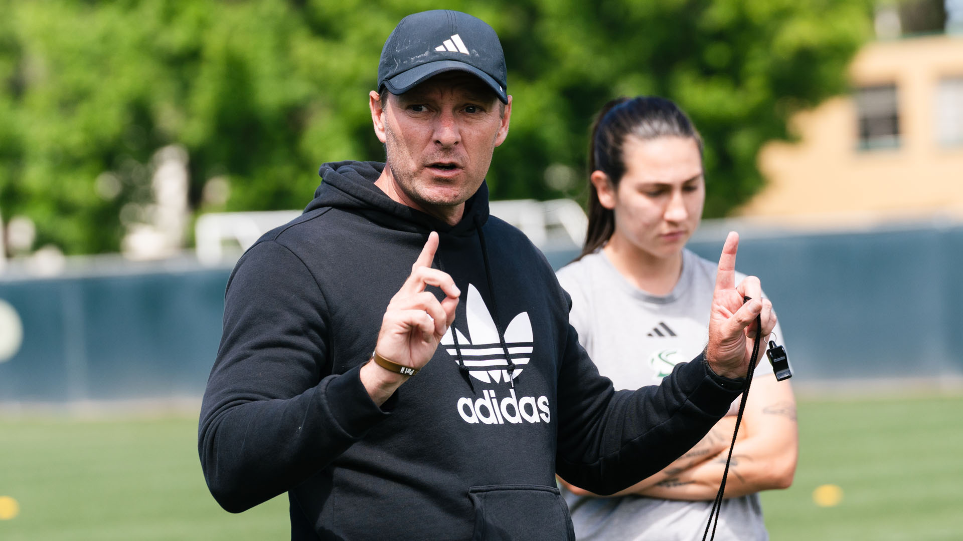 2026 WSOC Head Coach Tim Strader speaks with the team during a break in training in the spring of 2026