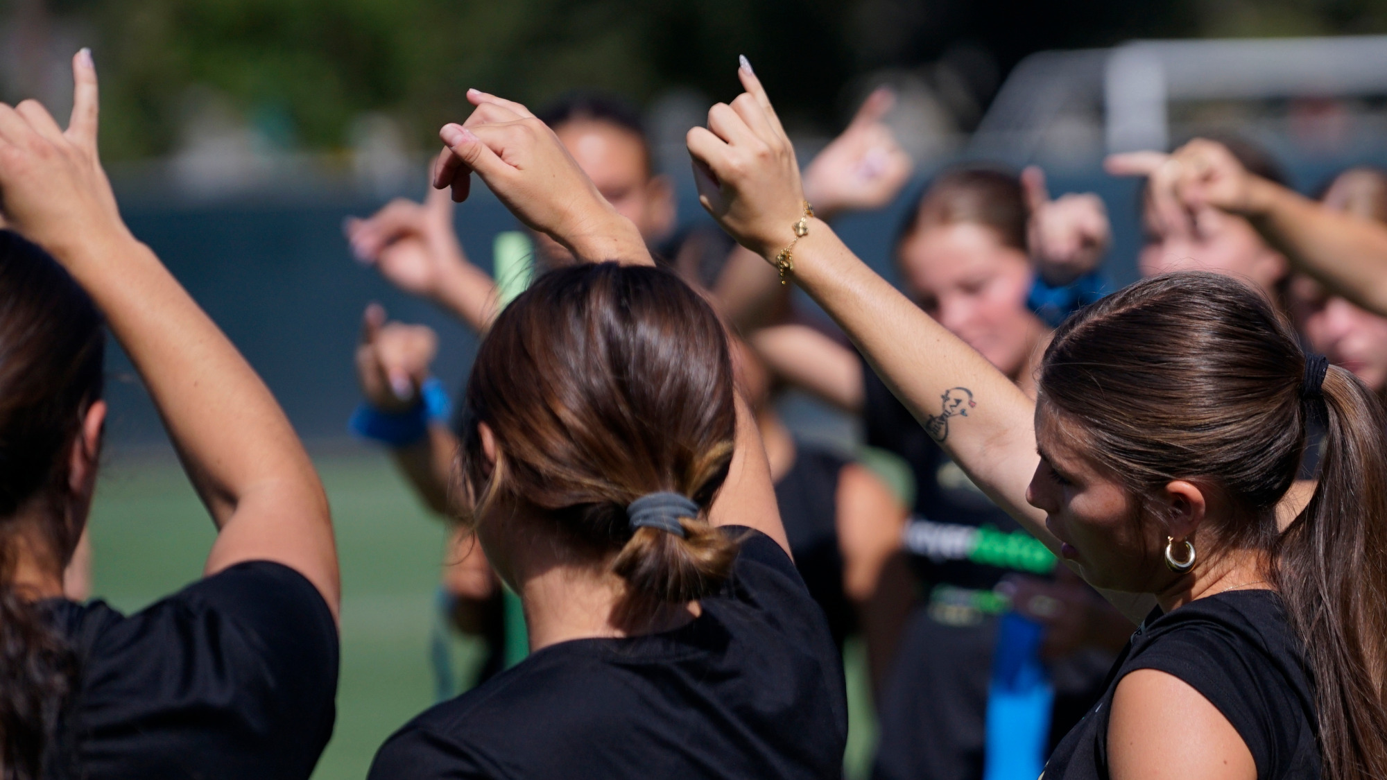 2026 WSOC players with Stingers Up in a team huddle following a preseason training session