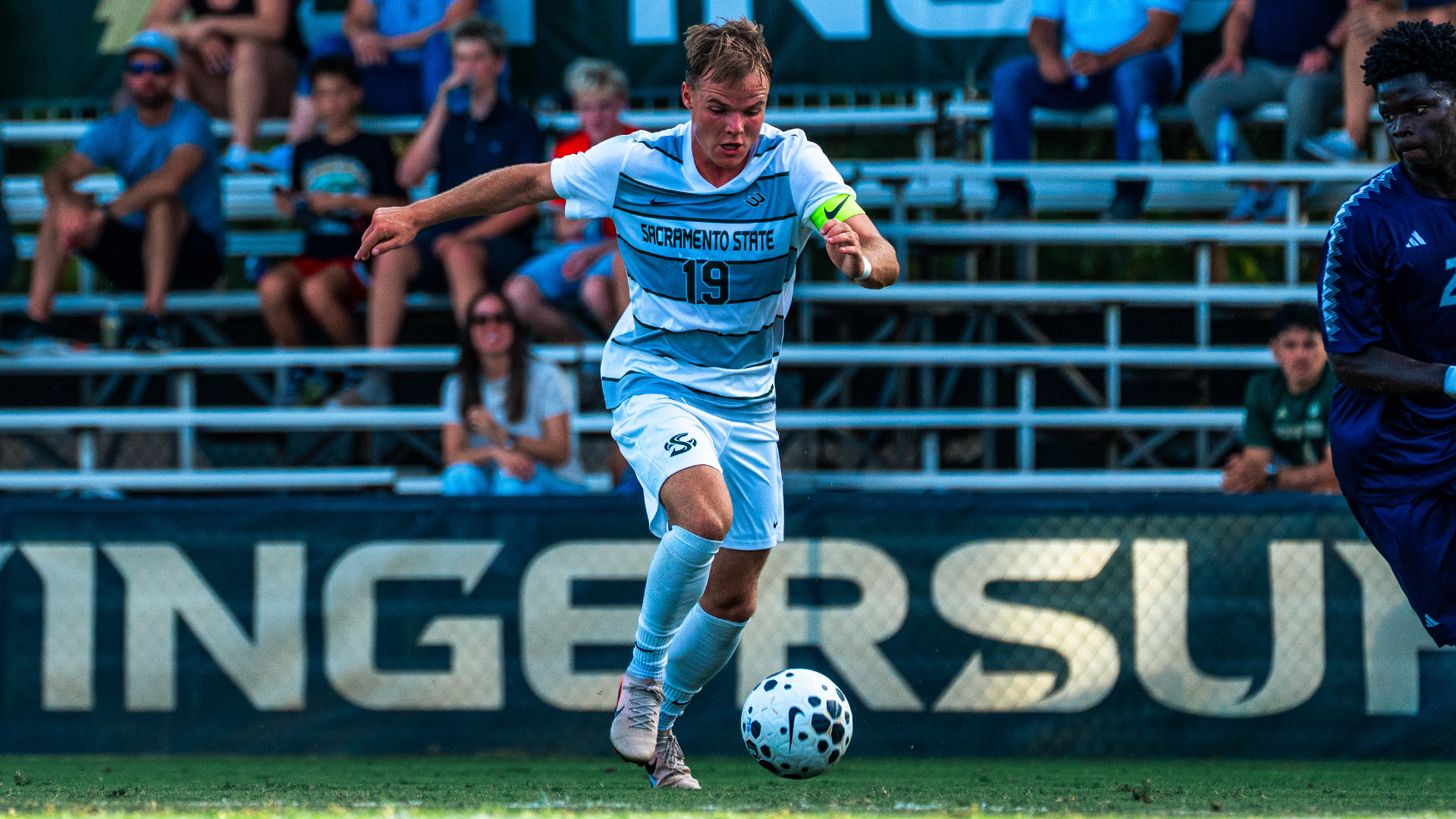 2026 MSOC Zac Giles drives a ball against the UC Davis defense during the Hornets' match against the Aggies