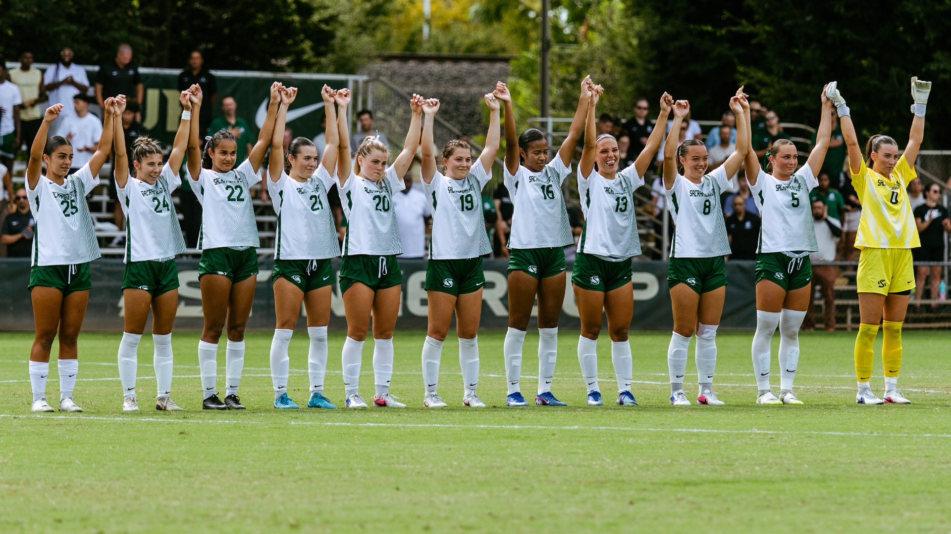 2026 WSOC Sacramento State starters face the bench and raise their hands together following the National Anthem against Southern Utah