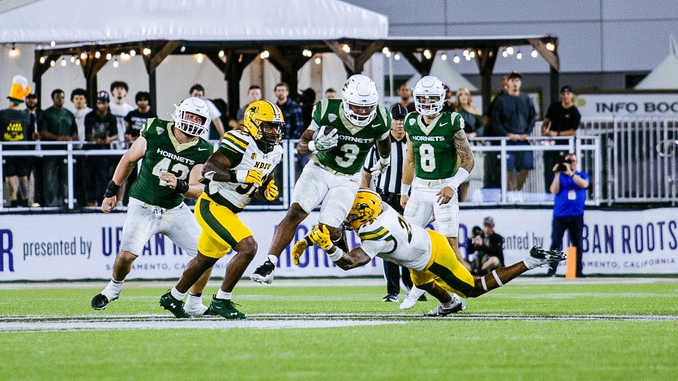 Cincere Rhaney jumps while carrying the ball against North Dakota State