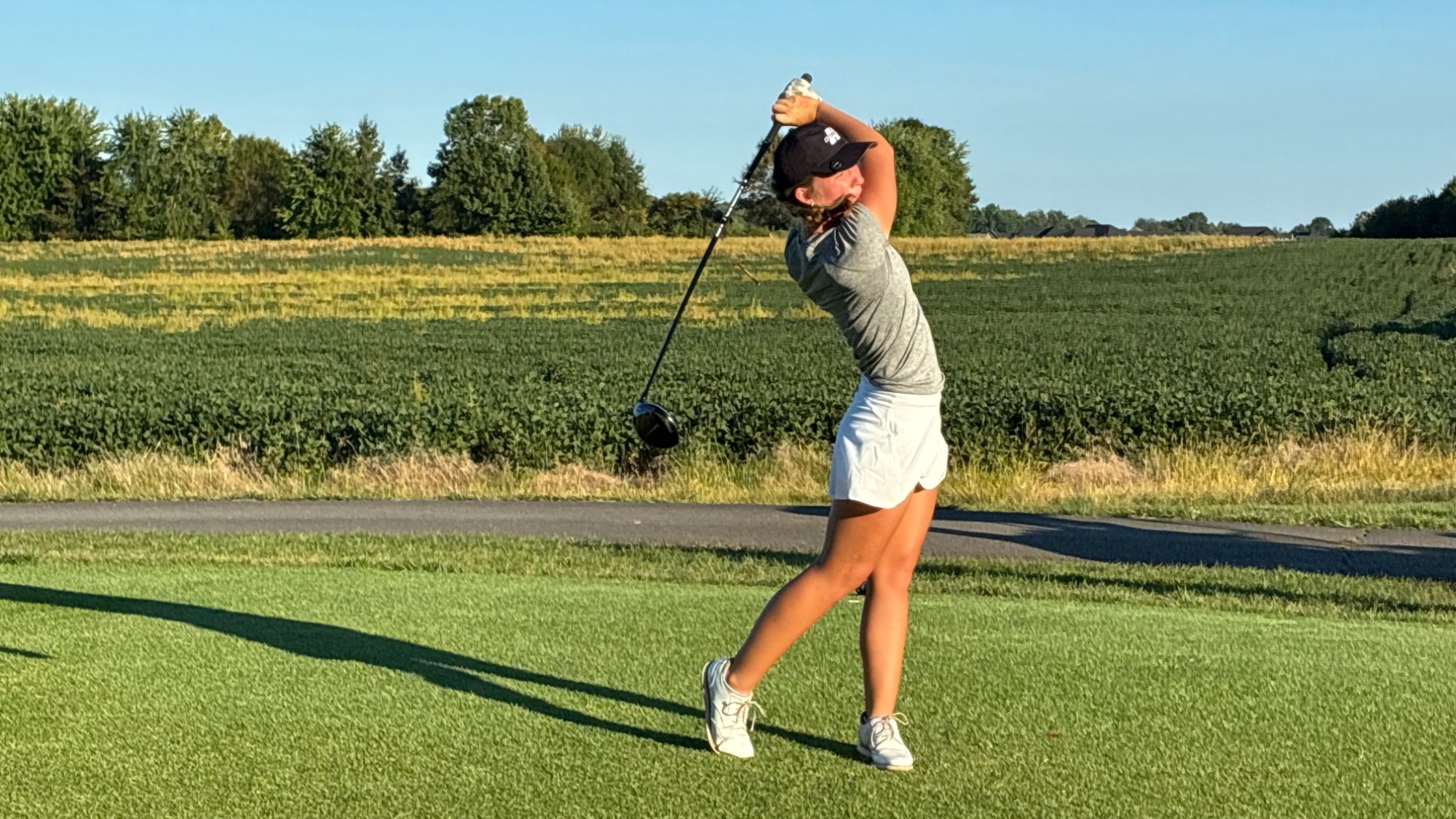 Teagen Muldoon finishes a swing in an early season golf tournament