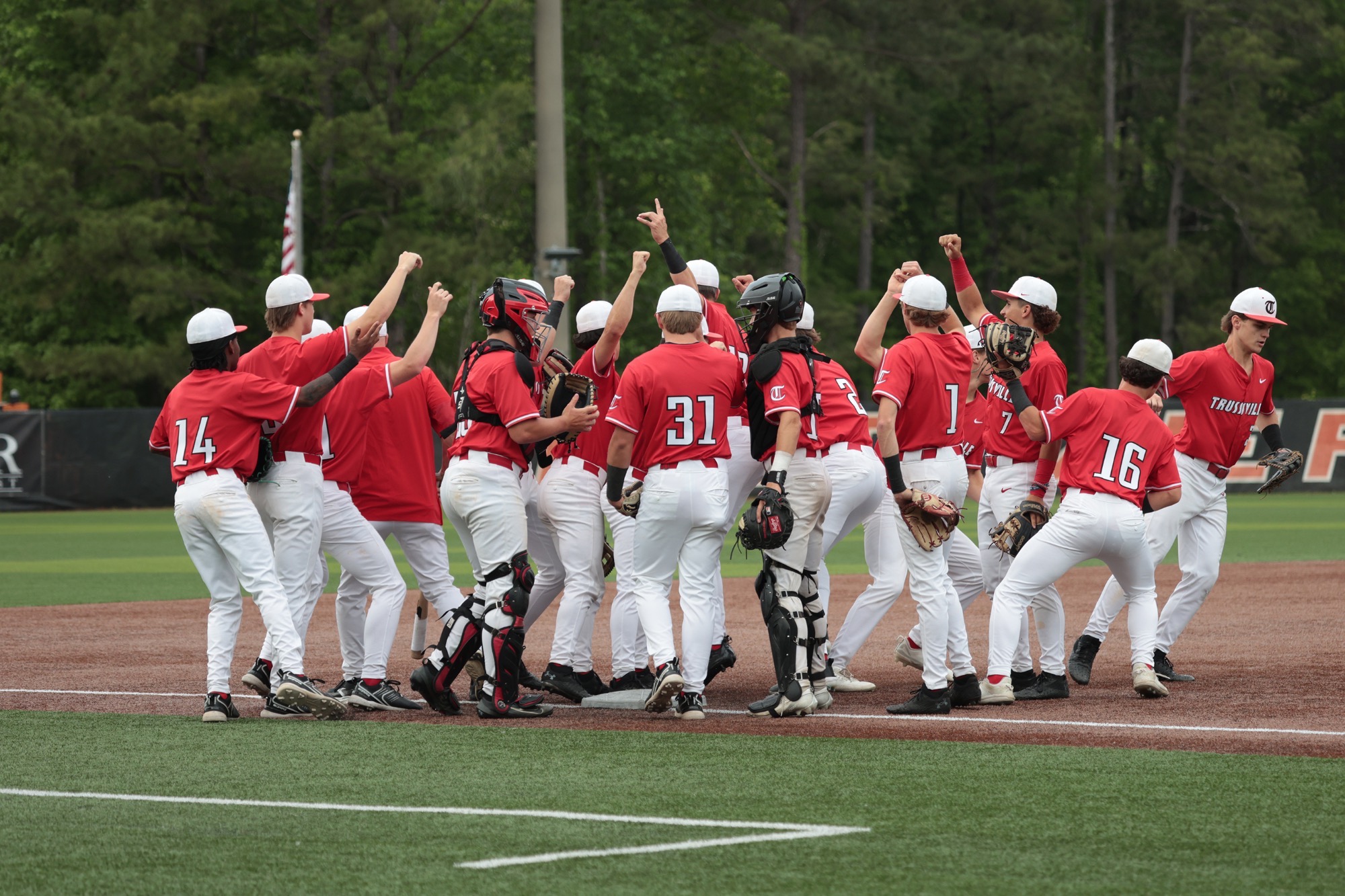 Varsity baseball celebrates beating Hoover