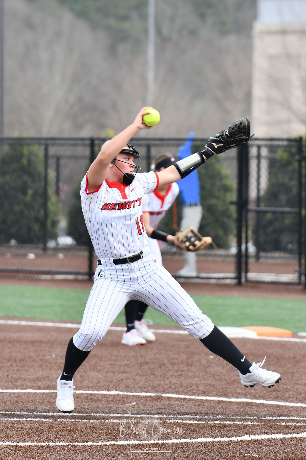 softball player pitching
