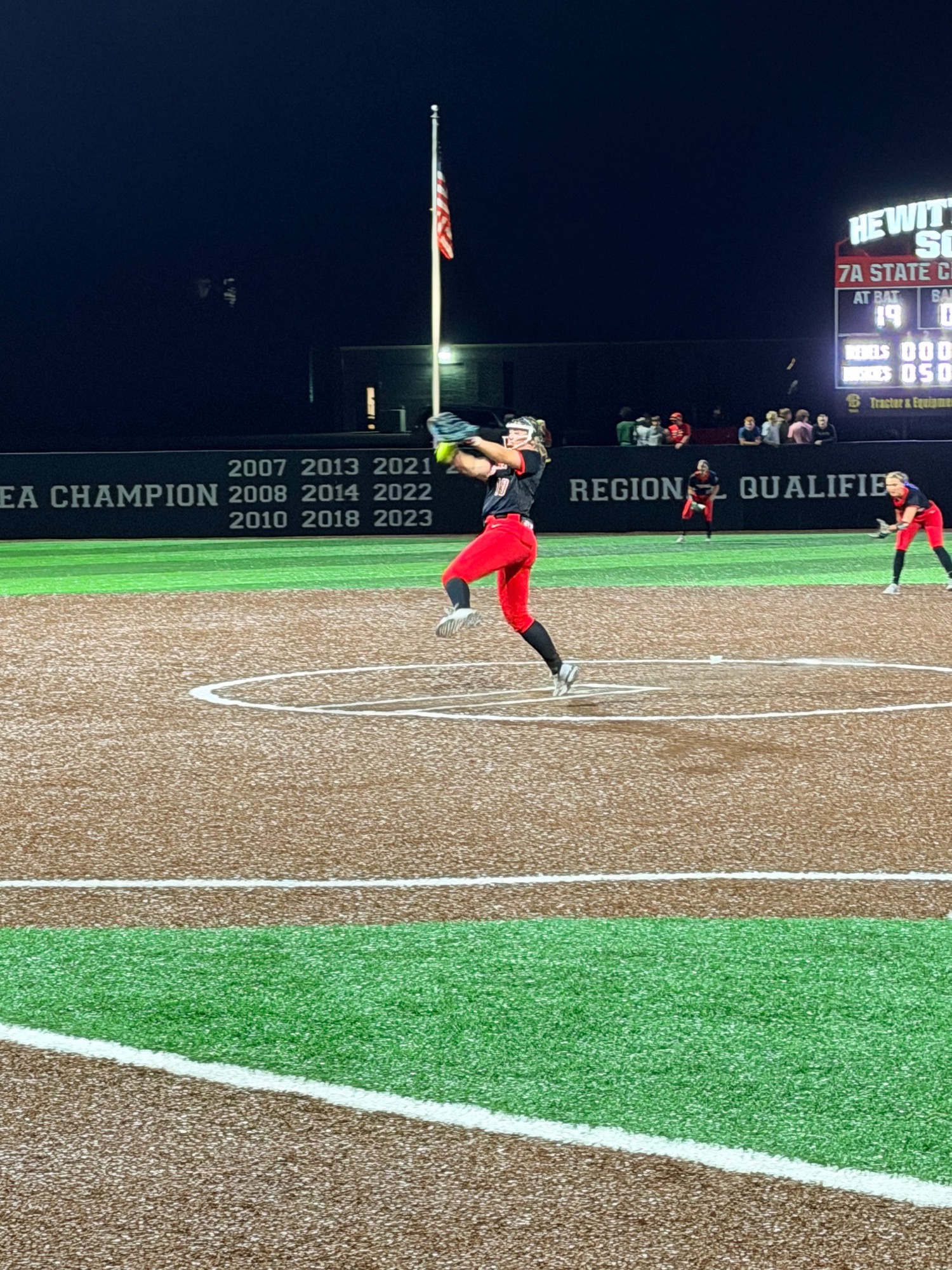 Softball player pitching
