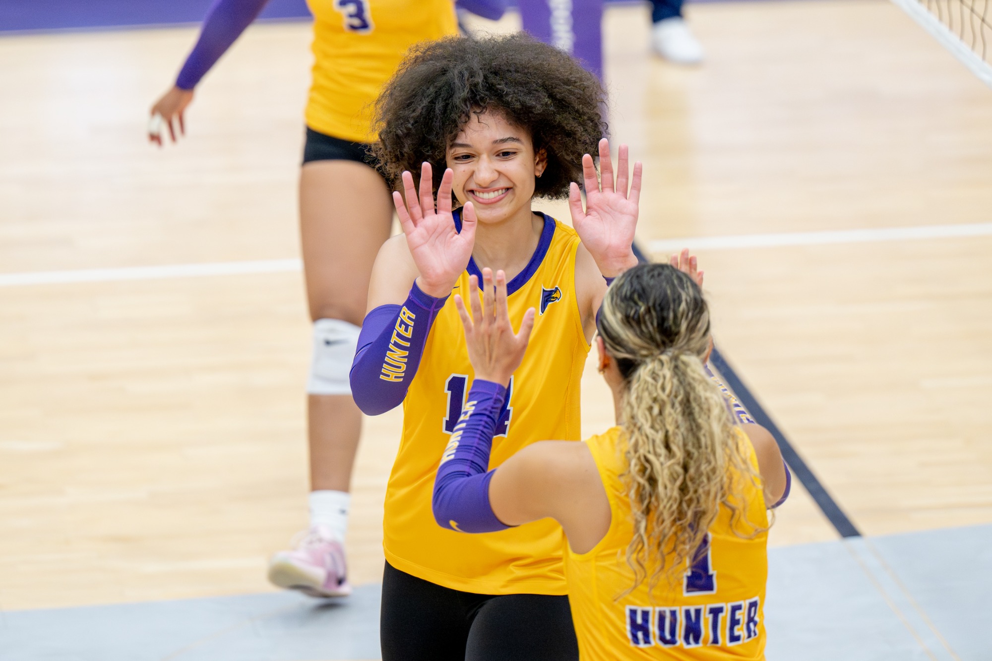 Hunter women's volleyball celebrates on the court