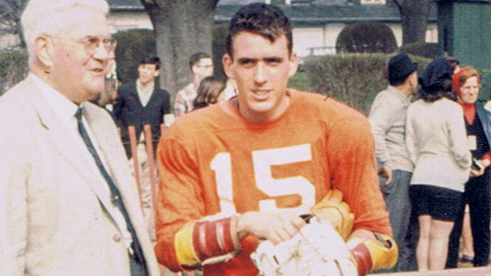 Stockton Buck in his Hobart lacrosse uniform standing next to Coach Babe Kraus