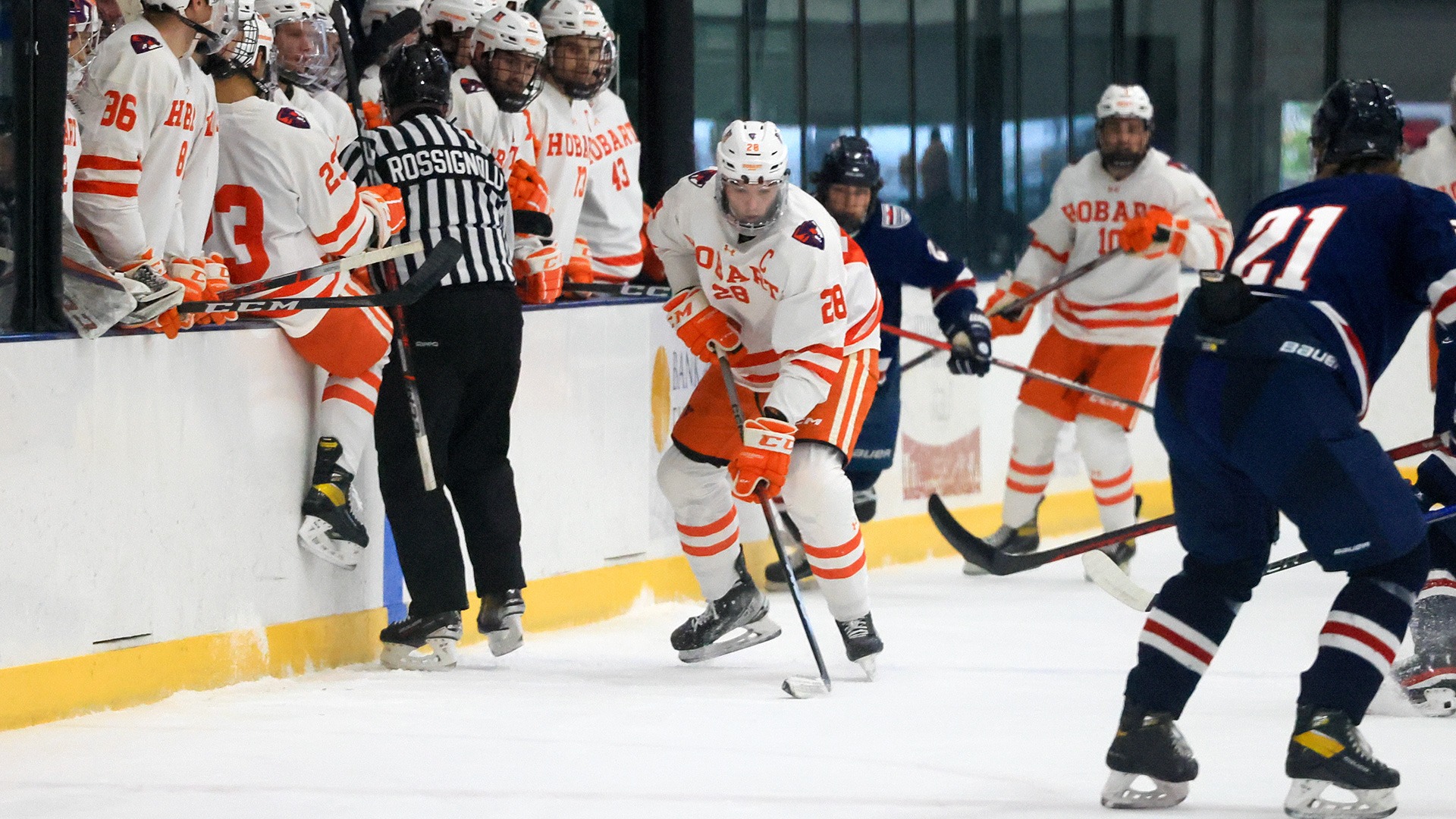 Artem Buzoverya holds the puck near his bench.