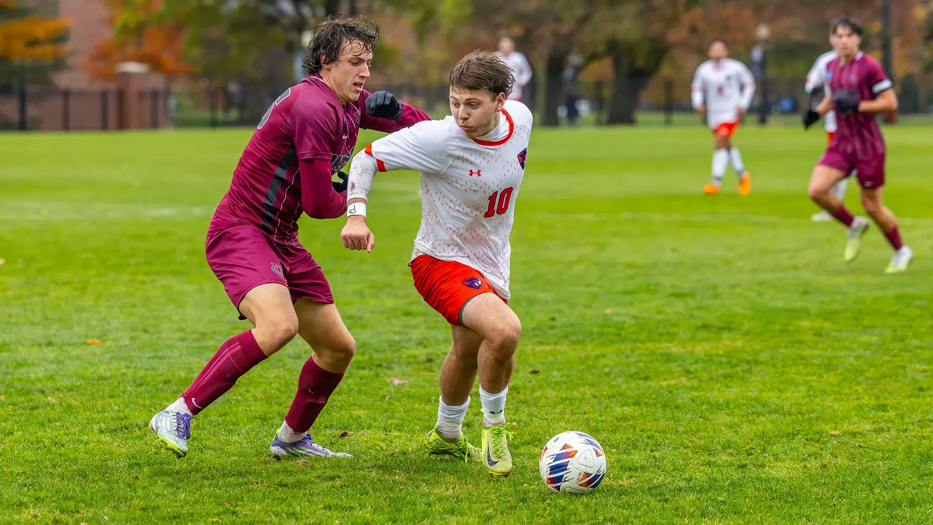 Brady Leitner Dribbles Away From a Vassar Defender