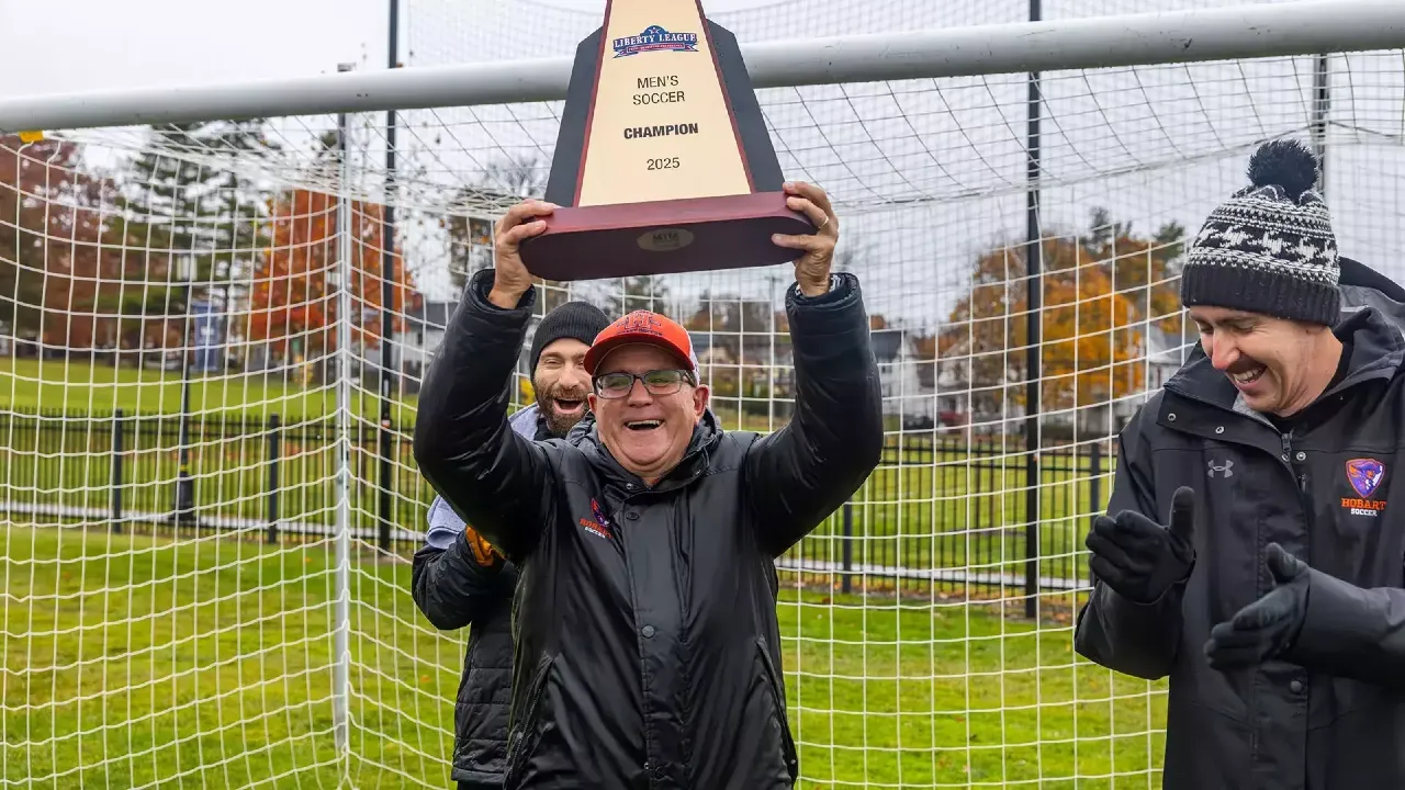 Head Coach Shawn Griffin Lifts the Liberty League Trophy