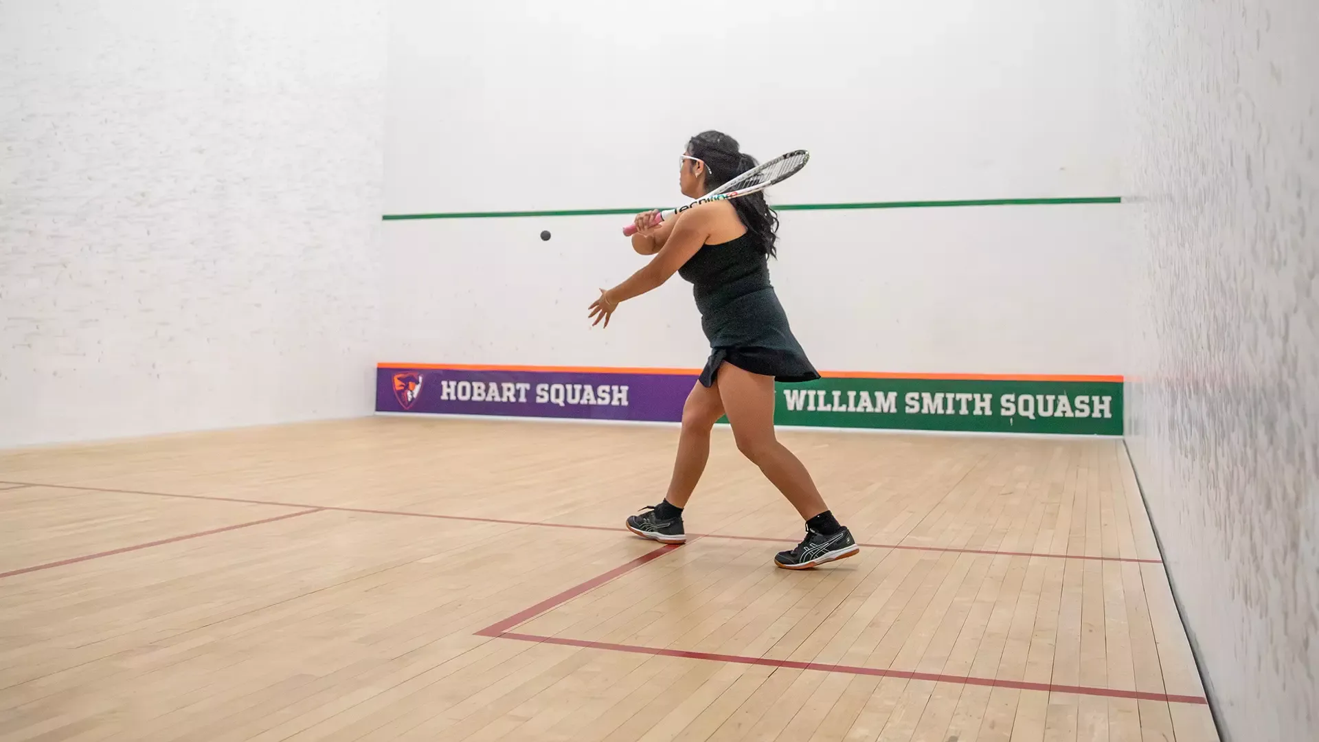 Kimberly Javier swinging at the ball