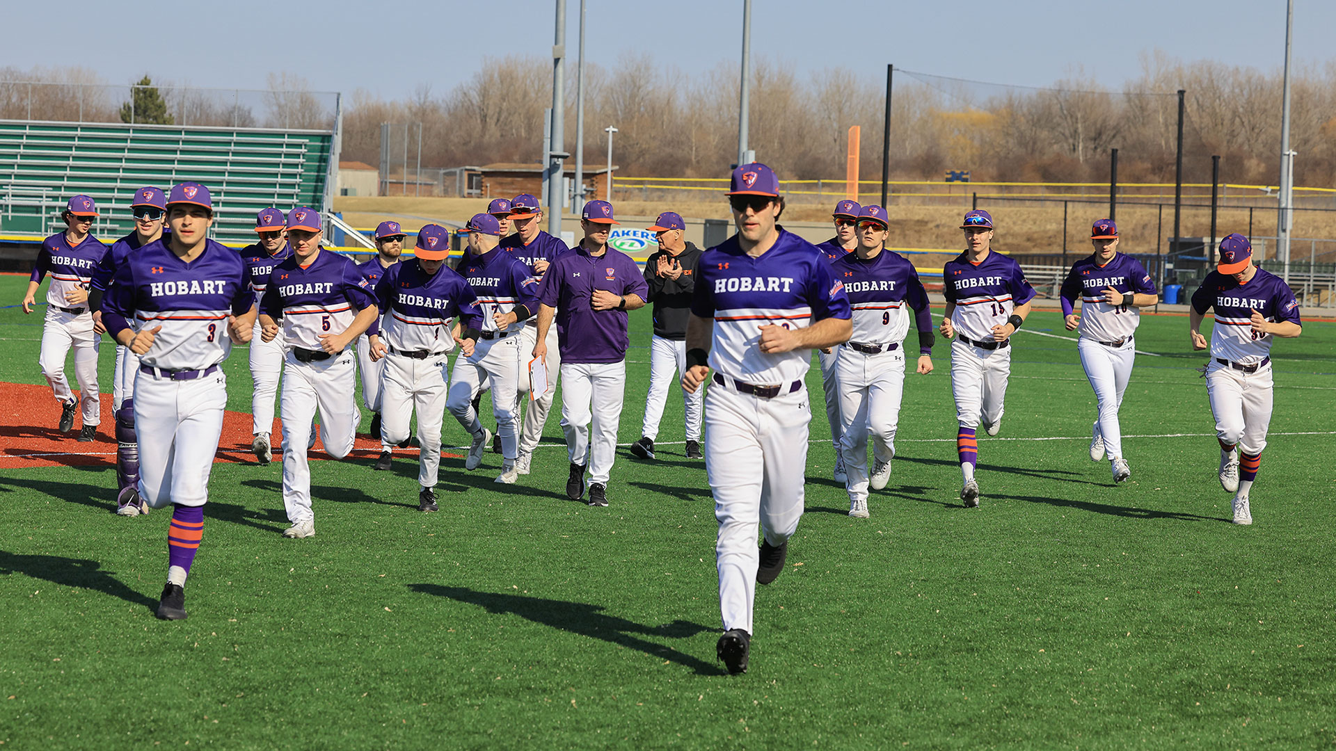 The Hobart baseball team jogs back to the dugout after pregame warm ups.