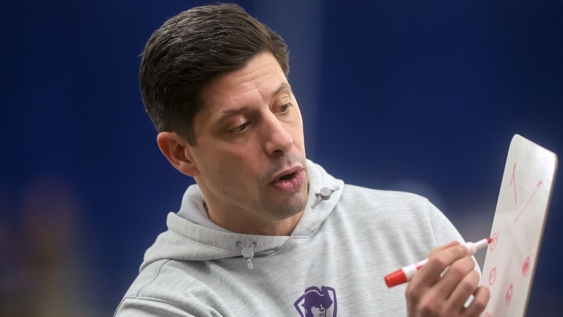 Greg Raymond draws up a play during a timeout in the Canisius game.