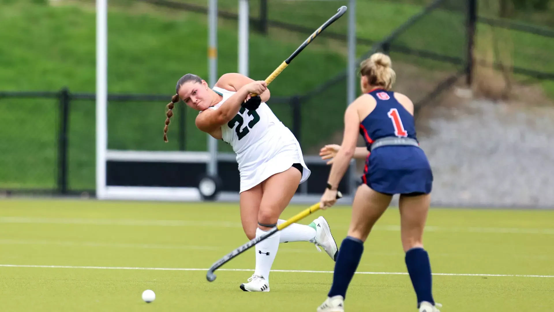 Caroline Kogut blasts the ball downfield past an attacker 