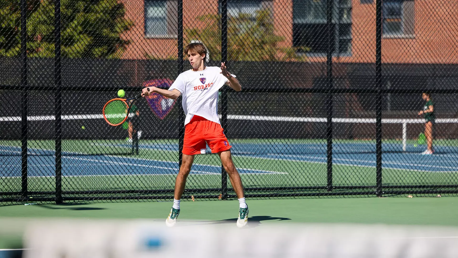 Nick Fischer jumps for the ball to return a forehand shot 