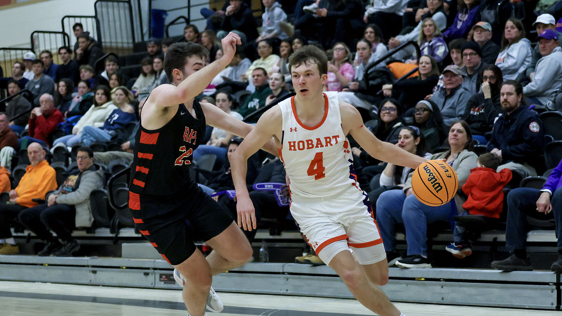 Alex Moesch dribbles past his defender.