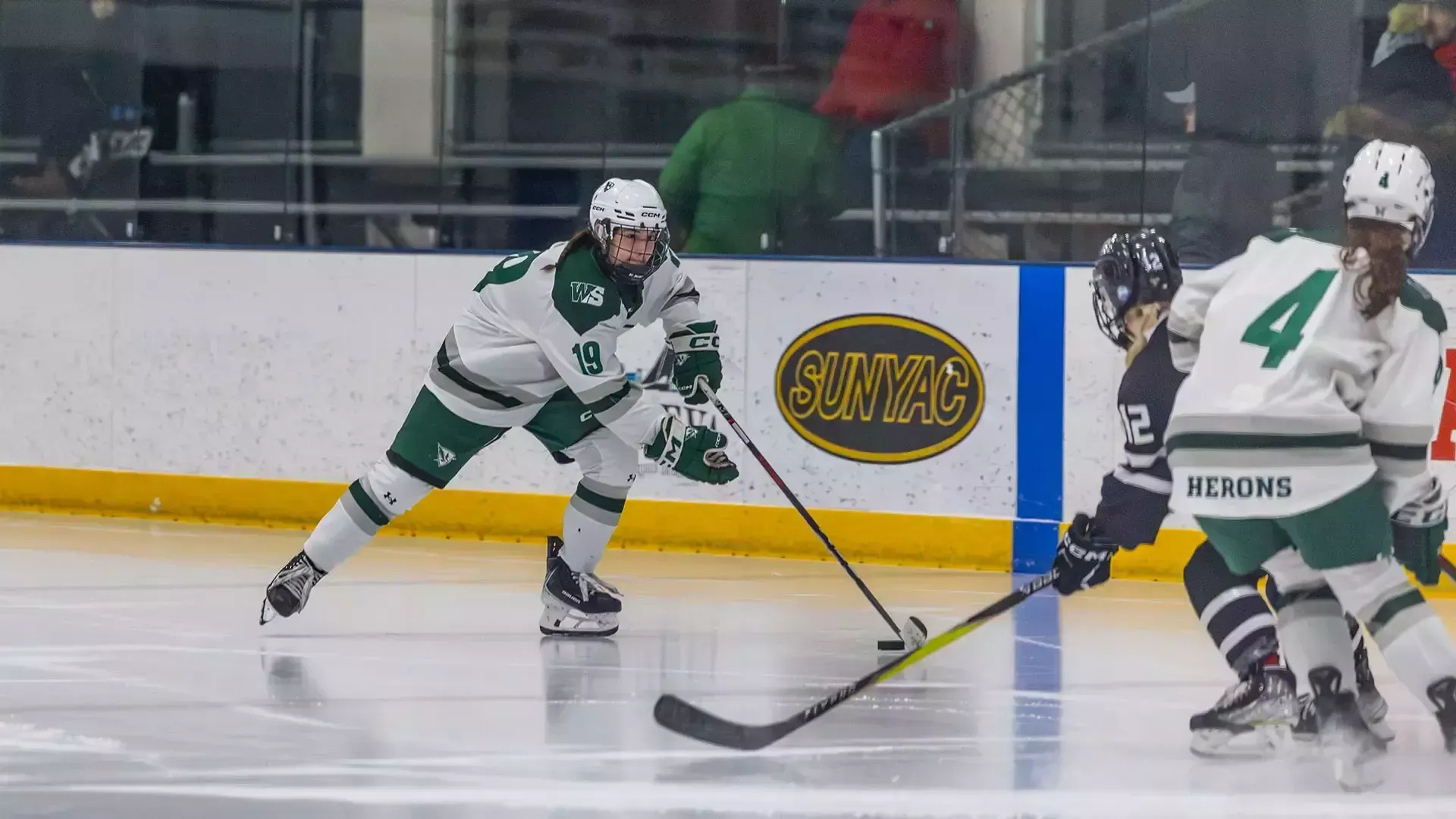 Bella Hacker skates with the puck