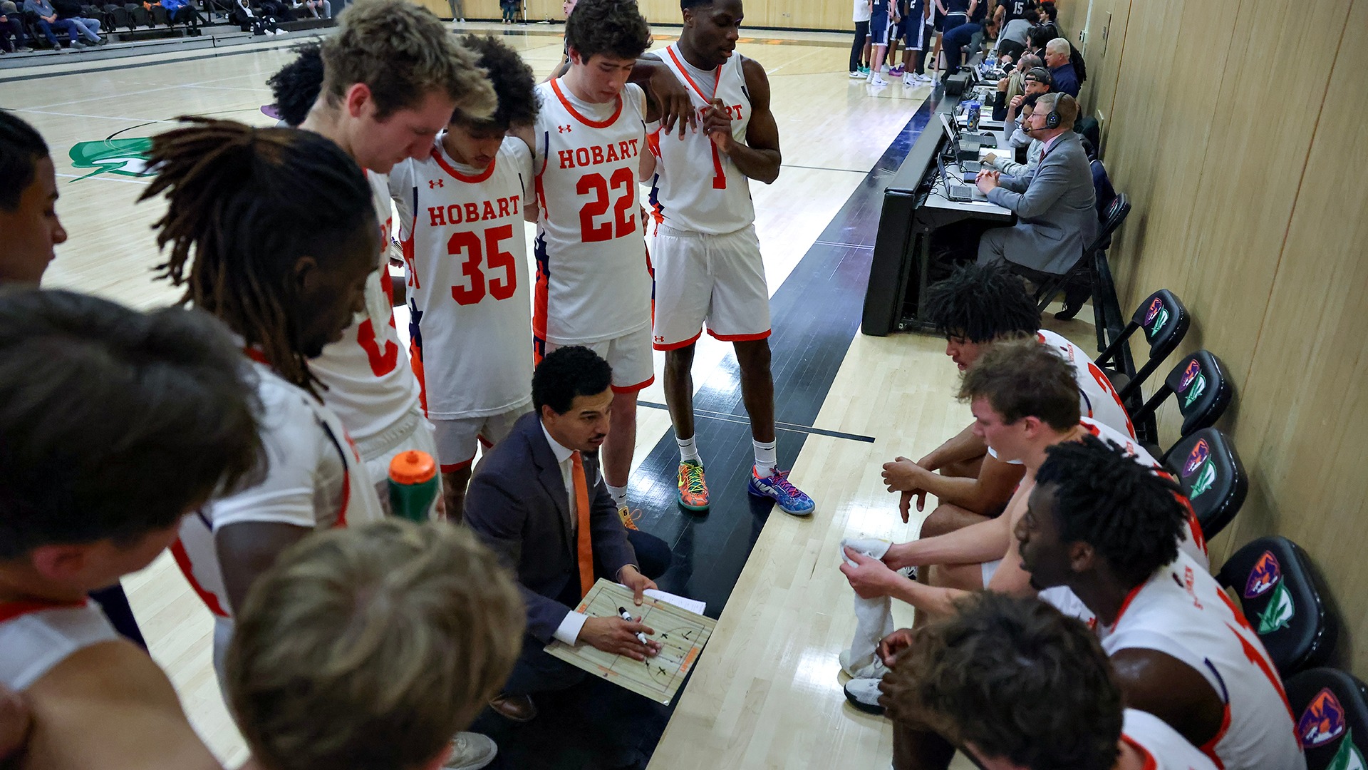 Head Coach Stefan Thompson draws up a play during a timeout.