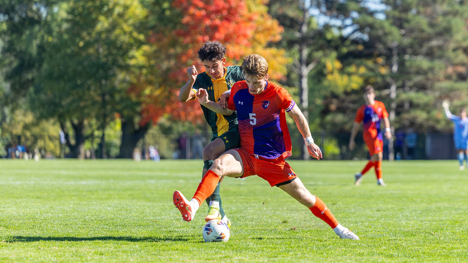 Quinn Phillips battles for a loose ball with a Clarkson player