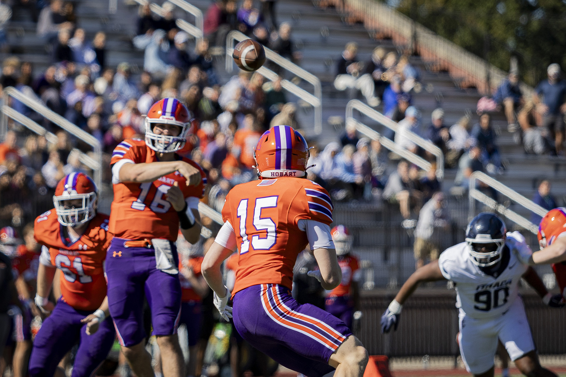 Jeremy Weiss (16) throws a short pass to James Mongno (15).