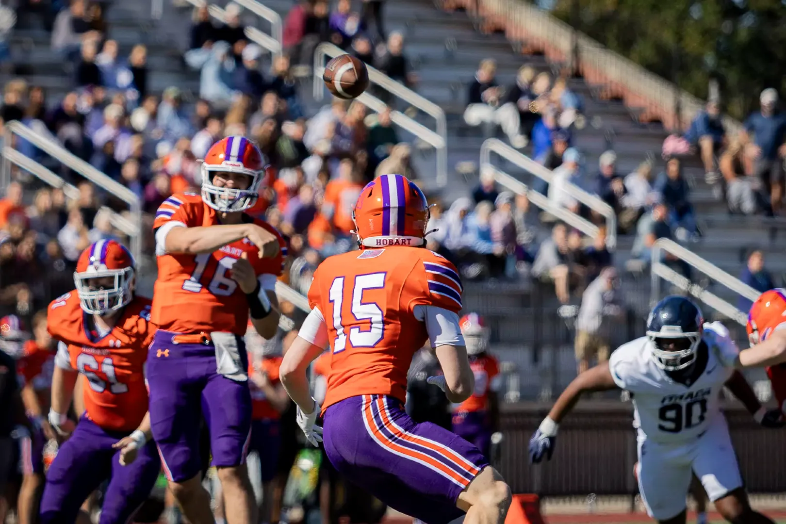 Jeremy Weiss (16) throws a short pass to James Mongno (15).