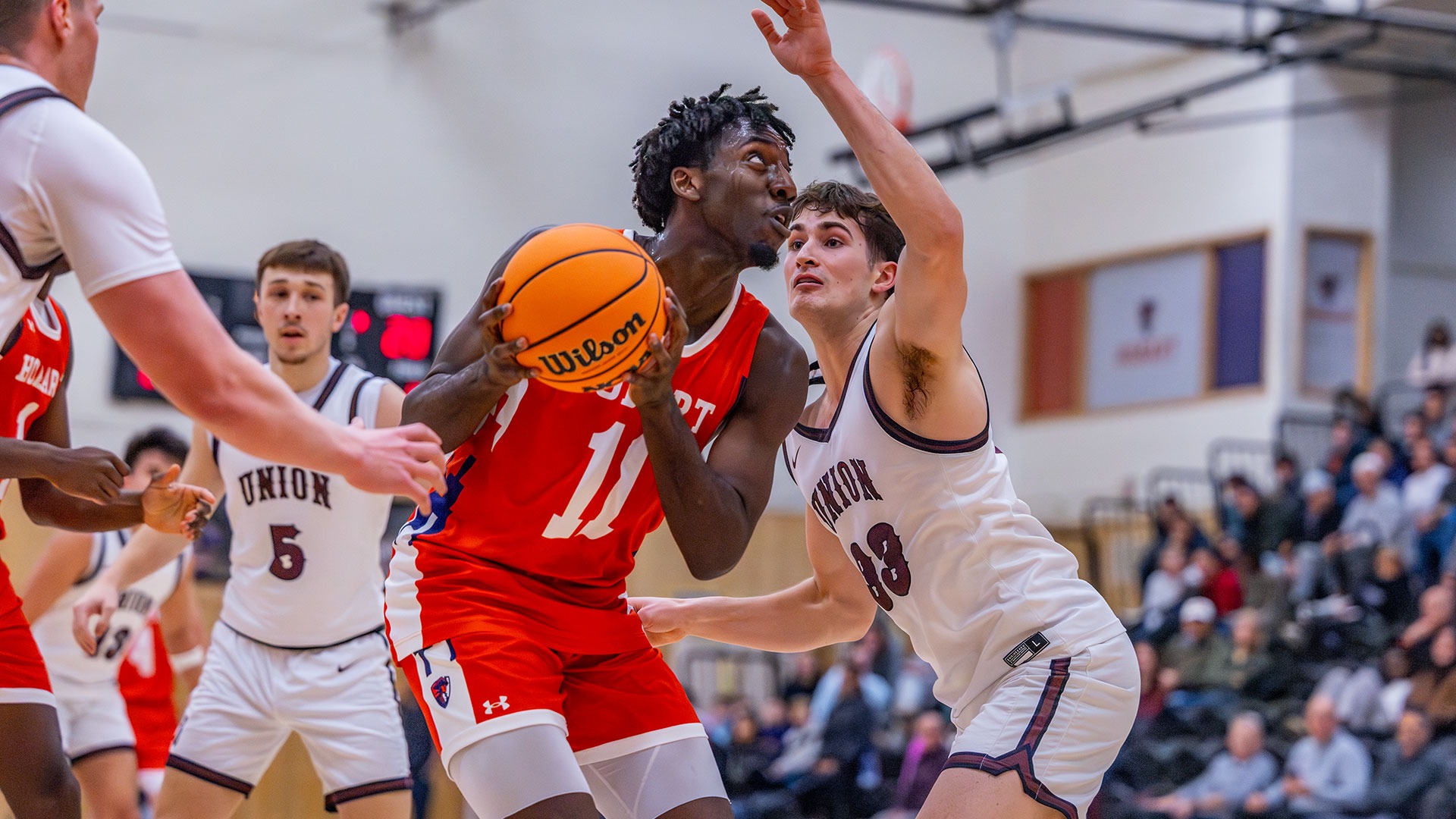 Surrounded by Union players, Allen Mordi looks to the rim.