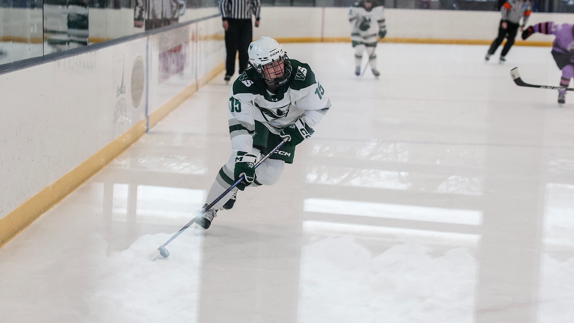 Finley Crosby skates the puck into the offensive zone