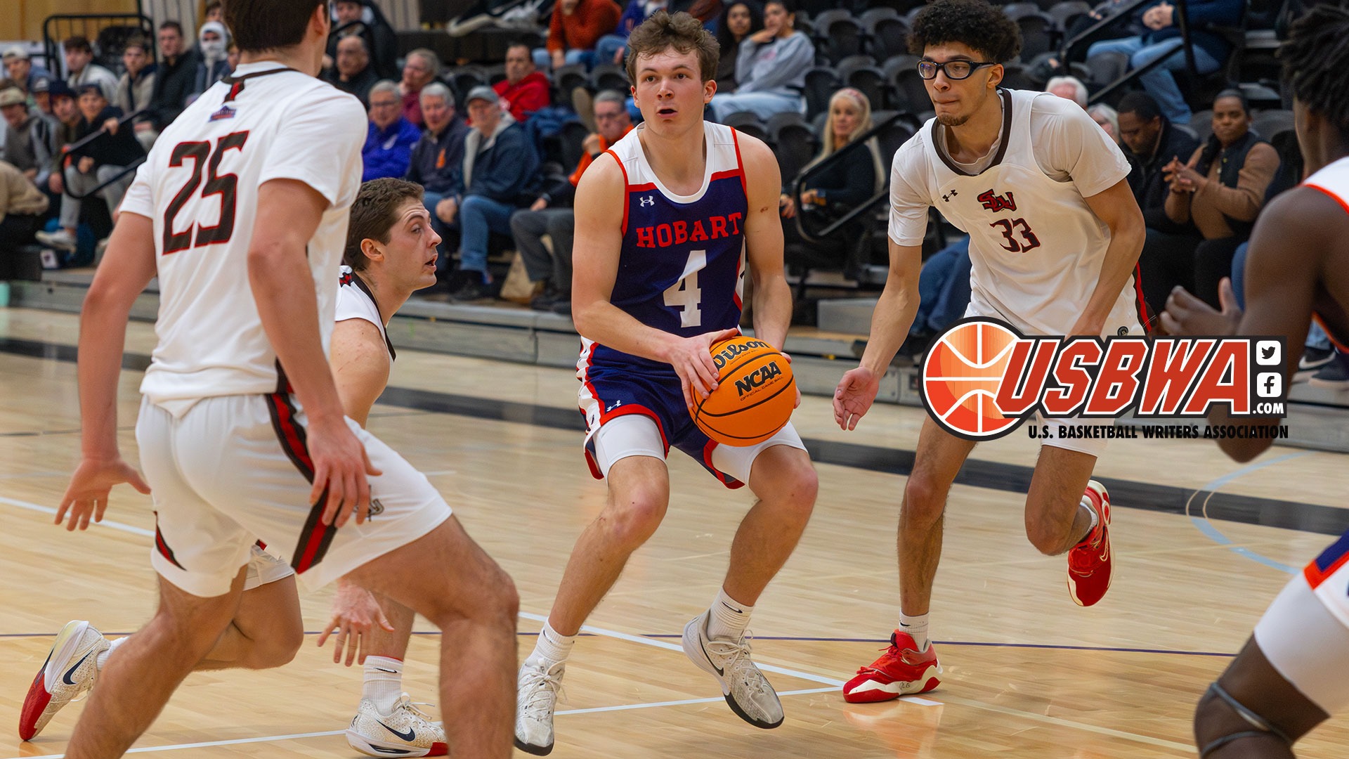 Alex Moesch jump stops surrounded by three defenders.