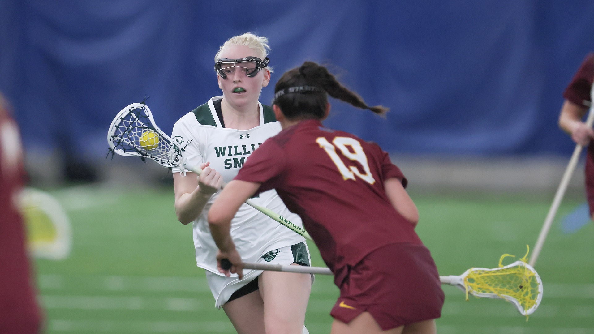 Caitie Baker clears a ball against St. John Fisher