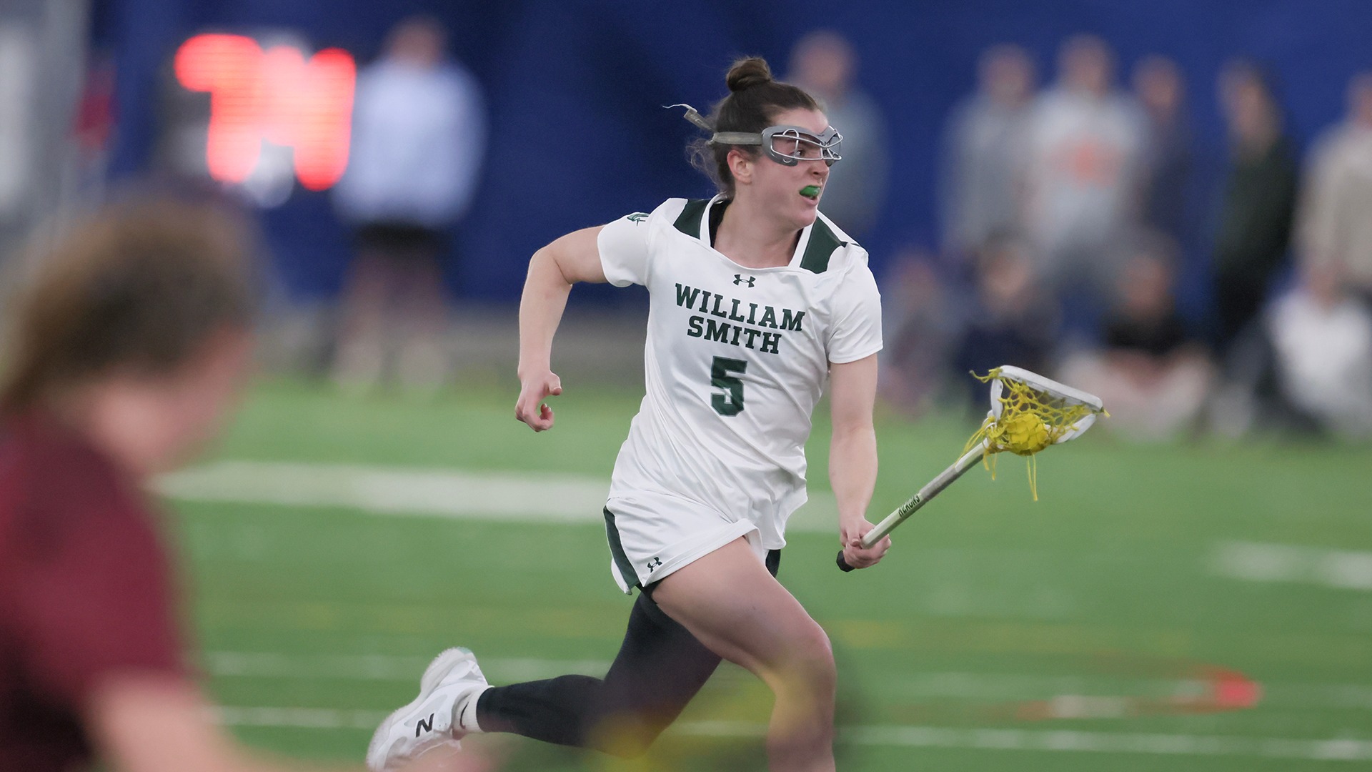 Delaney Cassidy runs the ball through midfield against St. John Fisher