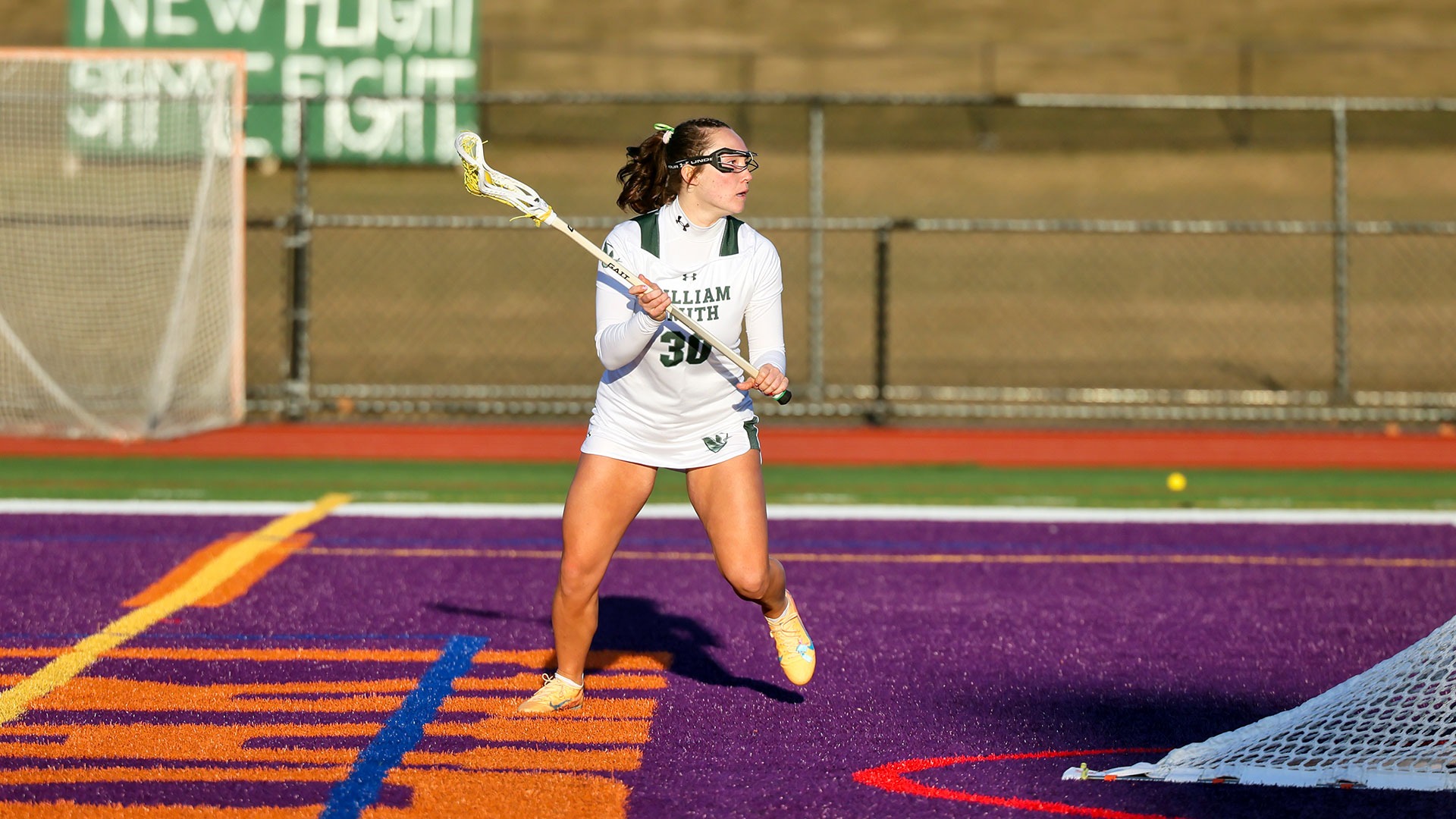 Mia Falco carries the ball behind the cage