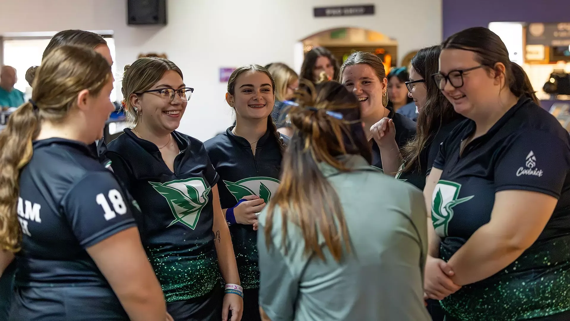 The William Smith bowling team listens to instructions from Head Coach Heather Sterner (back to camera).
