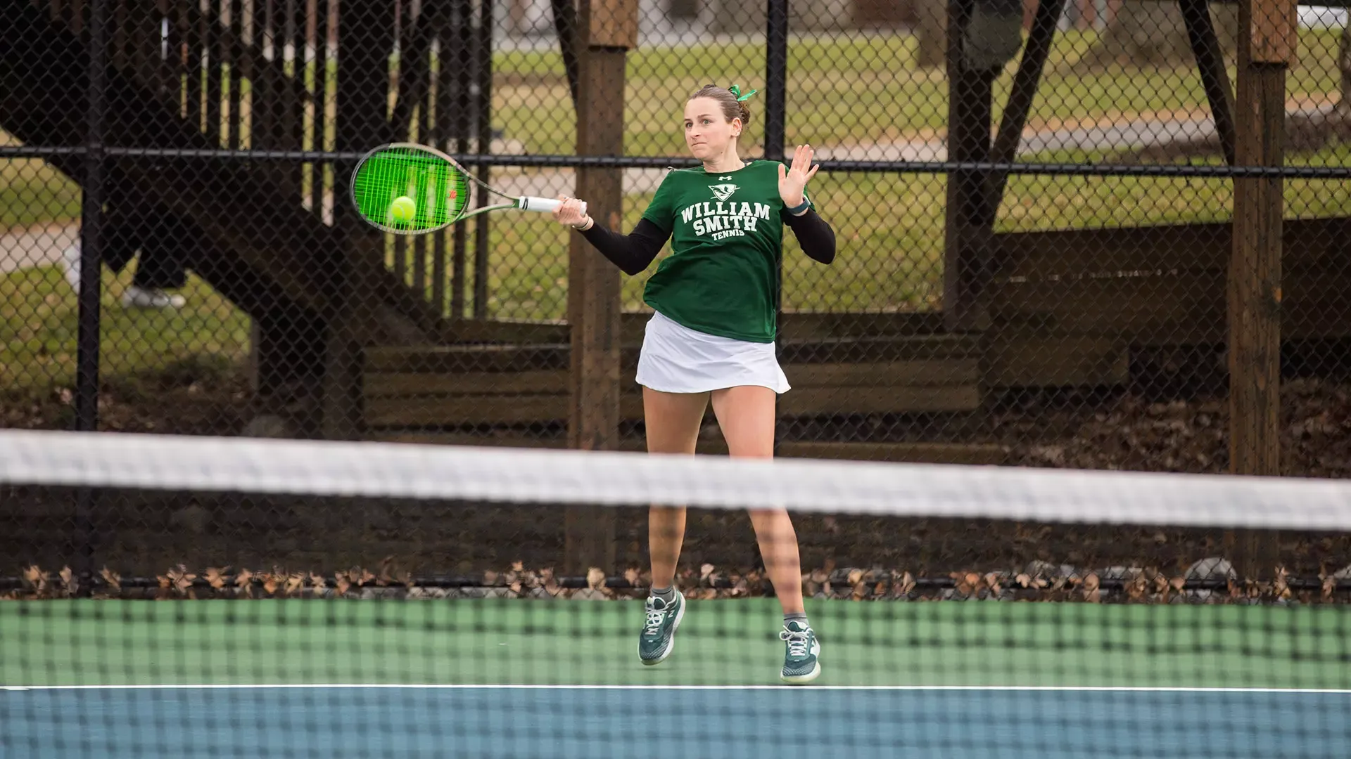 Haley Levine hits a forehand behind the baseline