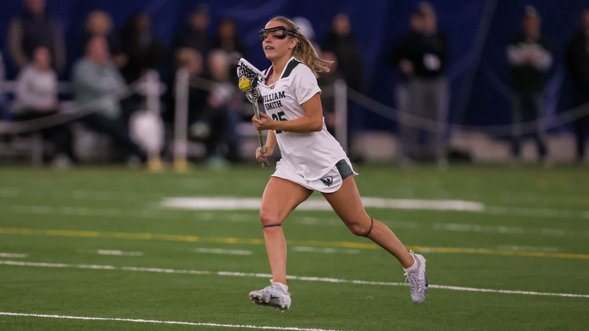 Grace Rund runs the ball through the midfield.