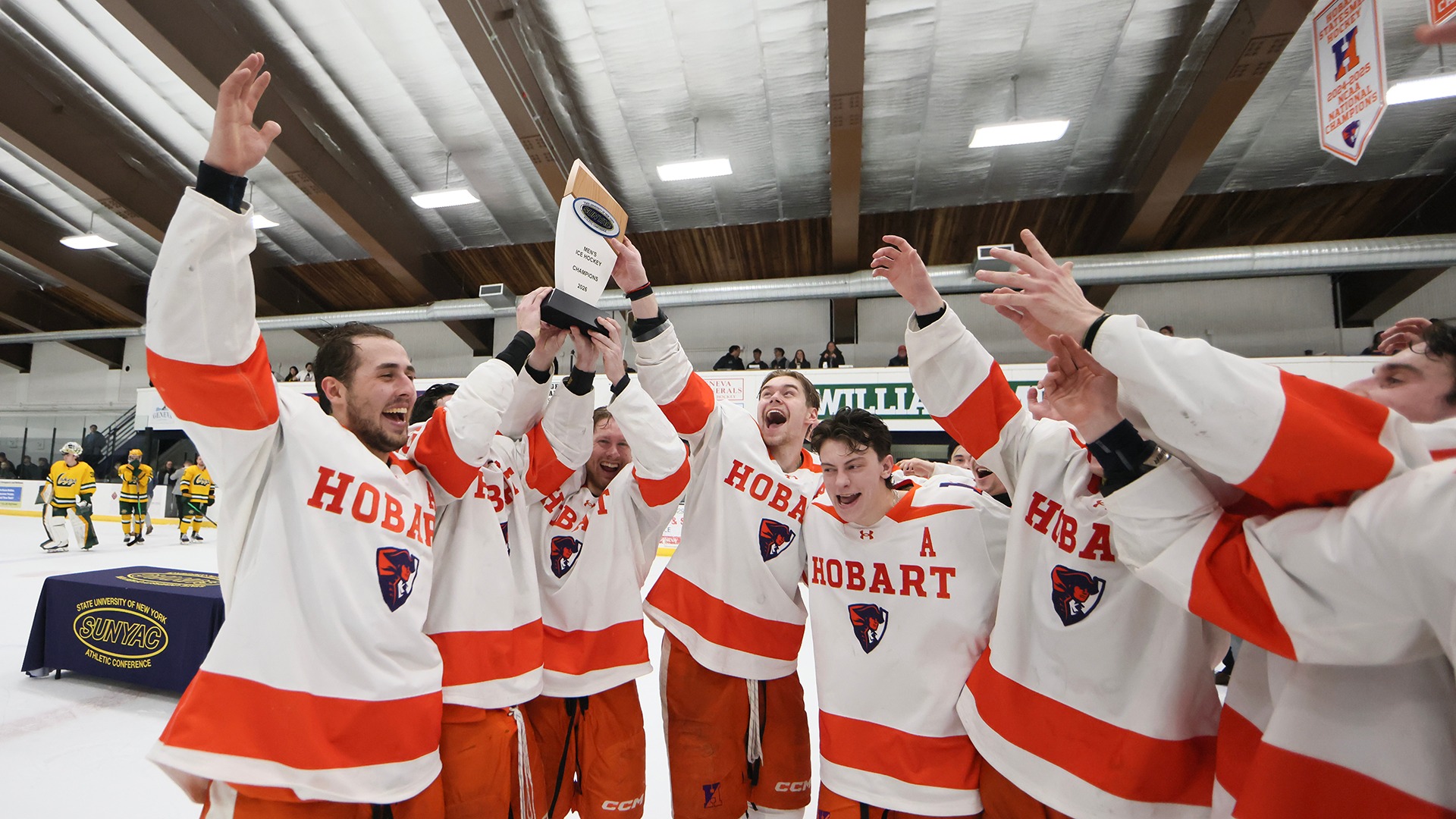 Hobart celebrates with the SUNYAC Trophy