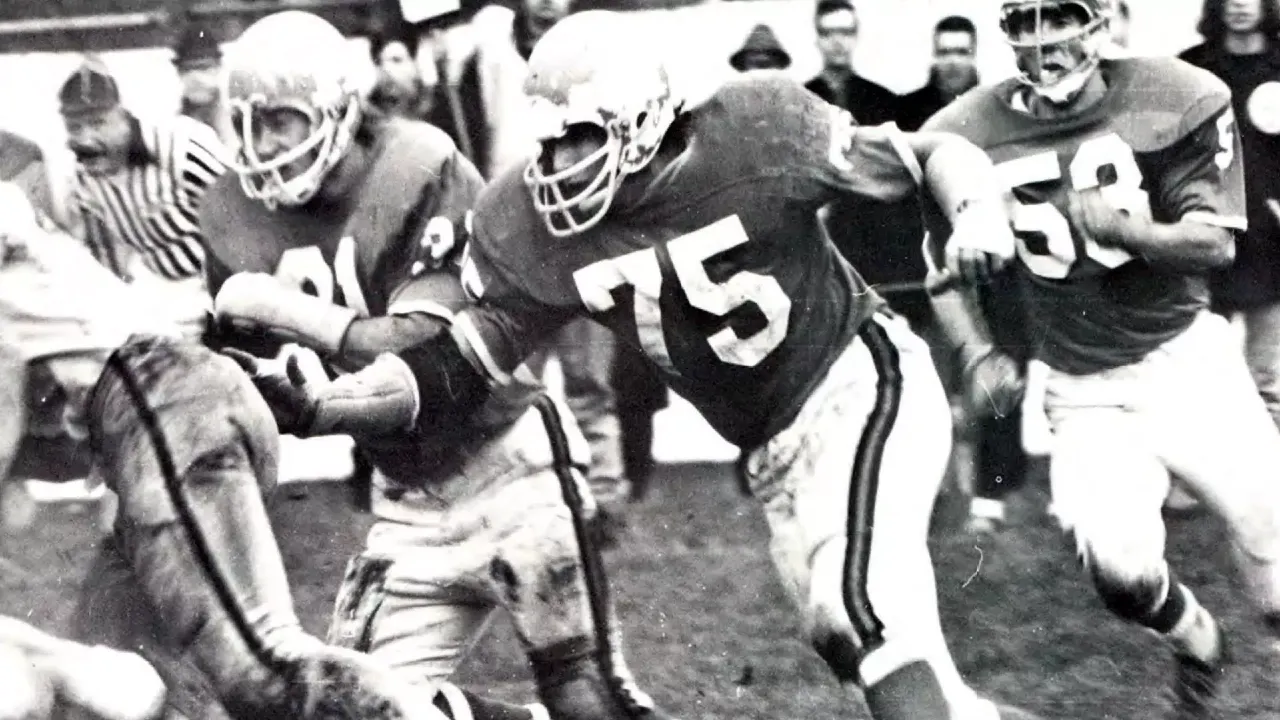 Defensive tackle Bill Zupan (#75) leads the charge into the opponent's backfield.