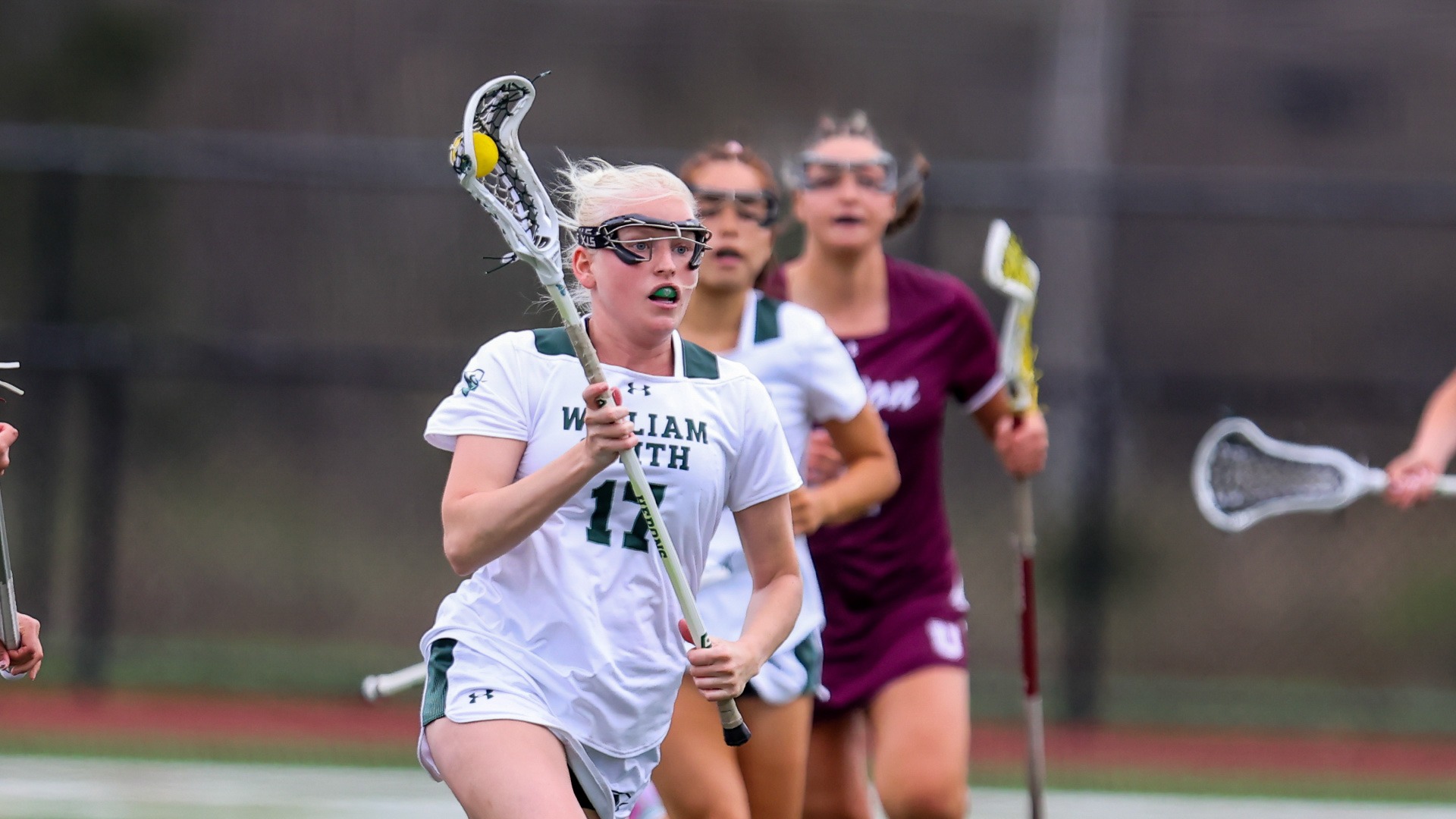 Caitie Baker runs with the ball through midfield