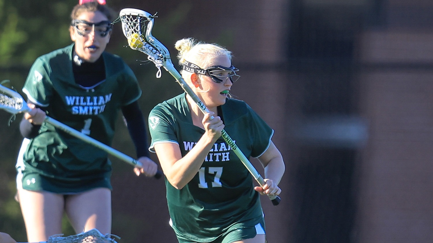 Caitie Baker carries the ball out of the defensive end of the field. 