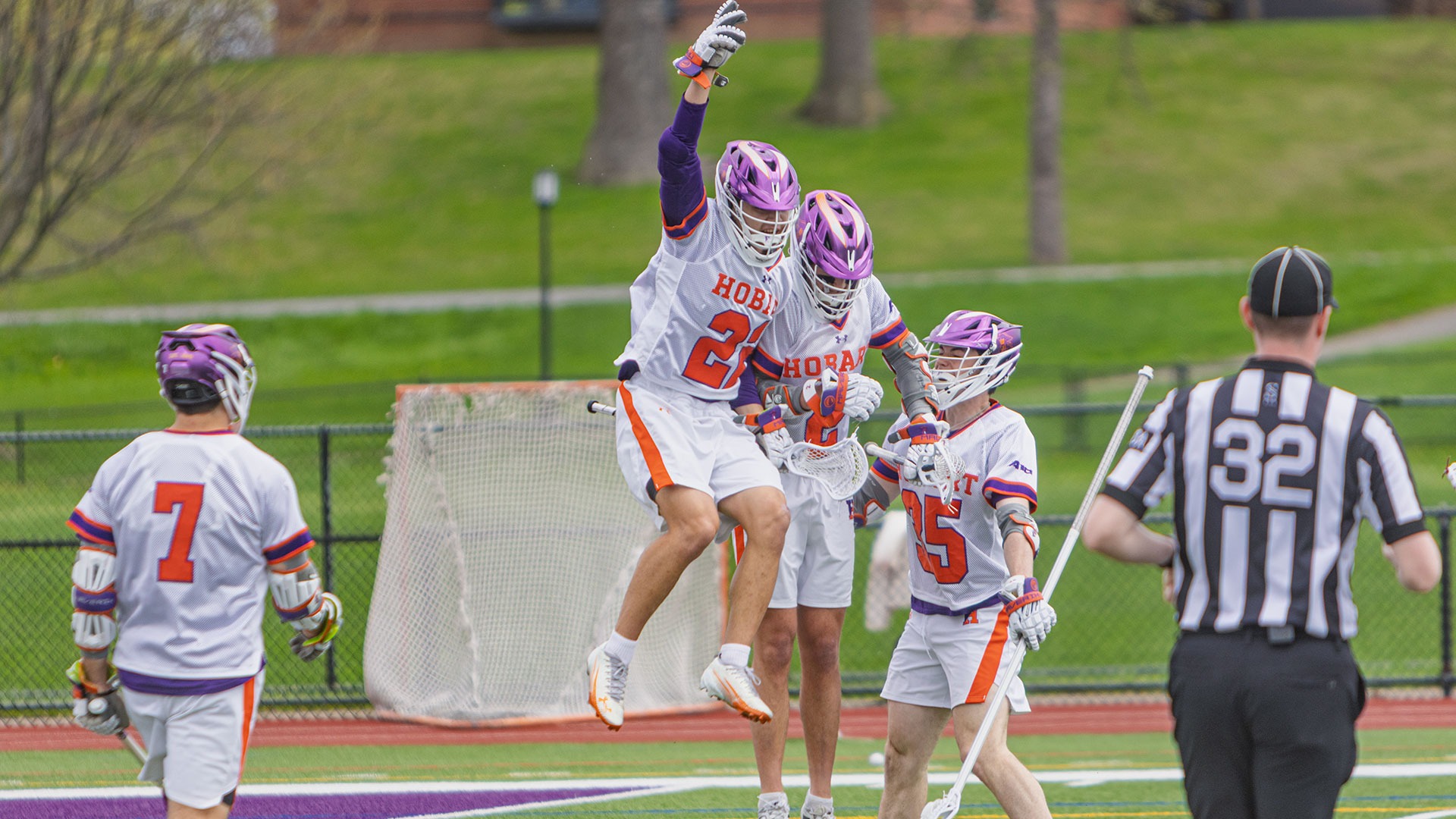 David Peterkin, Slade Engstrom, and Brady McEnroe celebrate a Hobart goal.