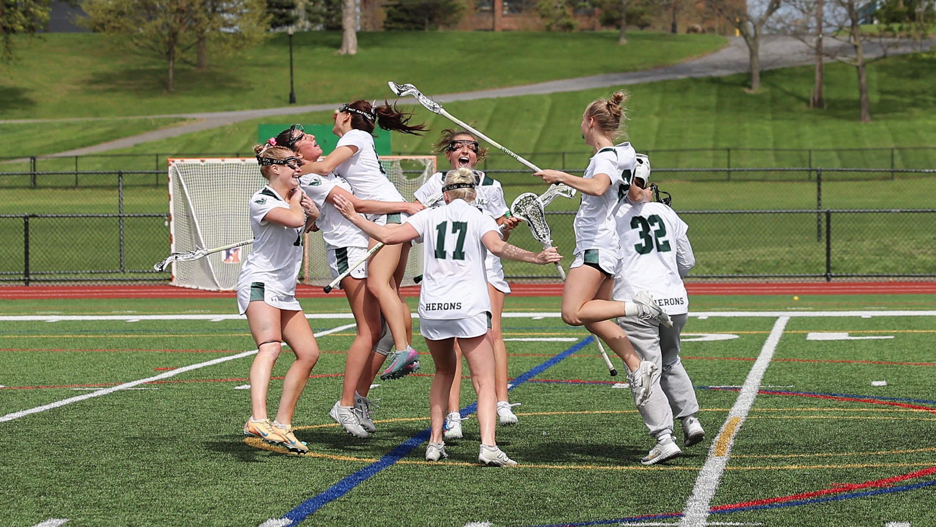 William Smith lacrosse players celebrate following their Liberty League Championship