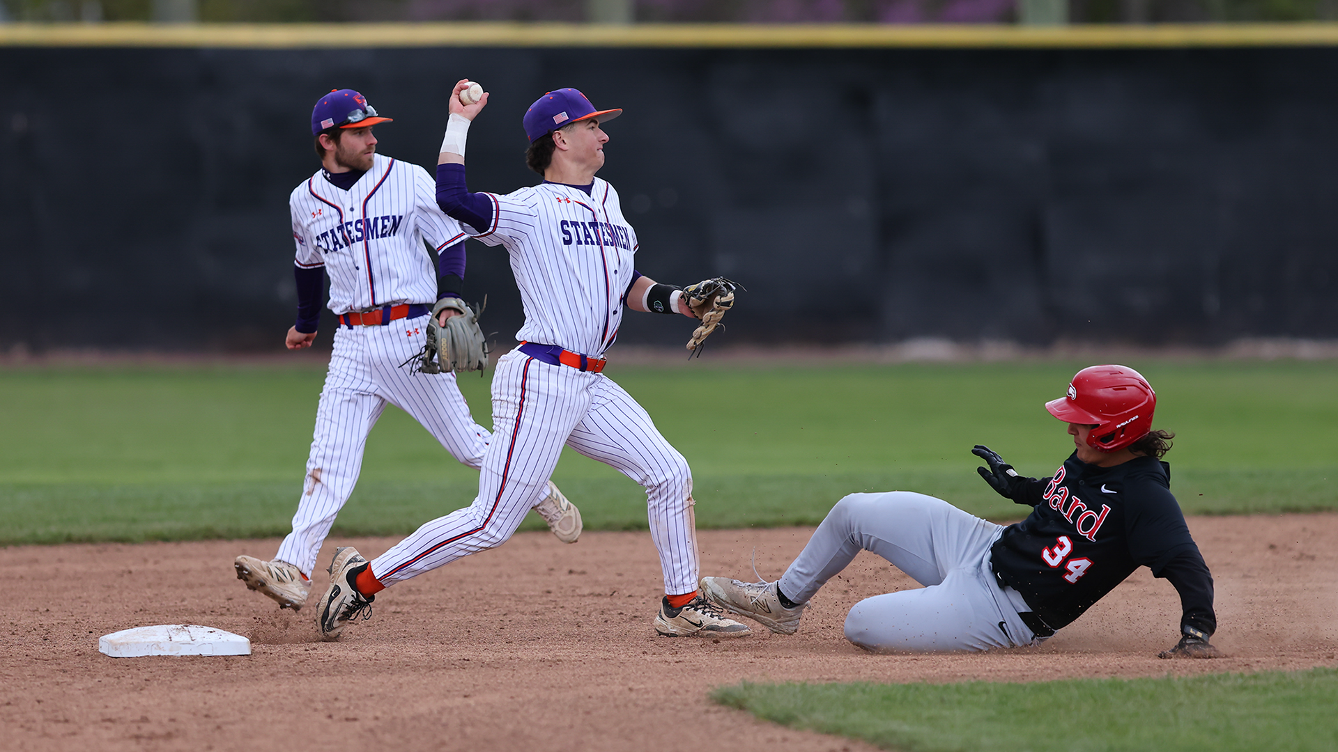 Jack O'Neil throws to first to complete a double play.