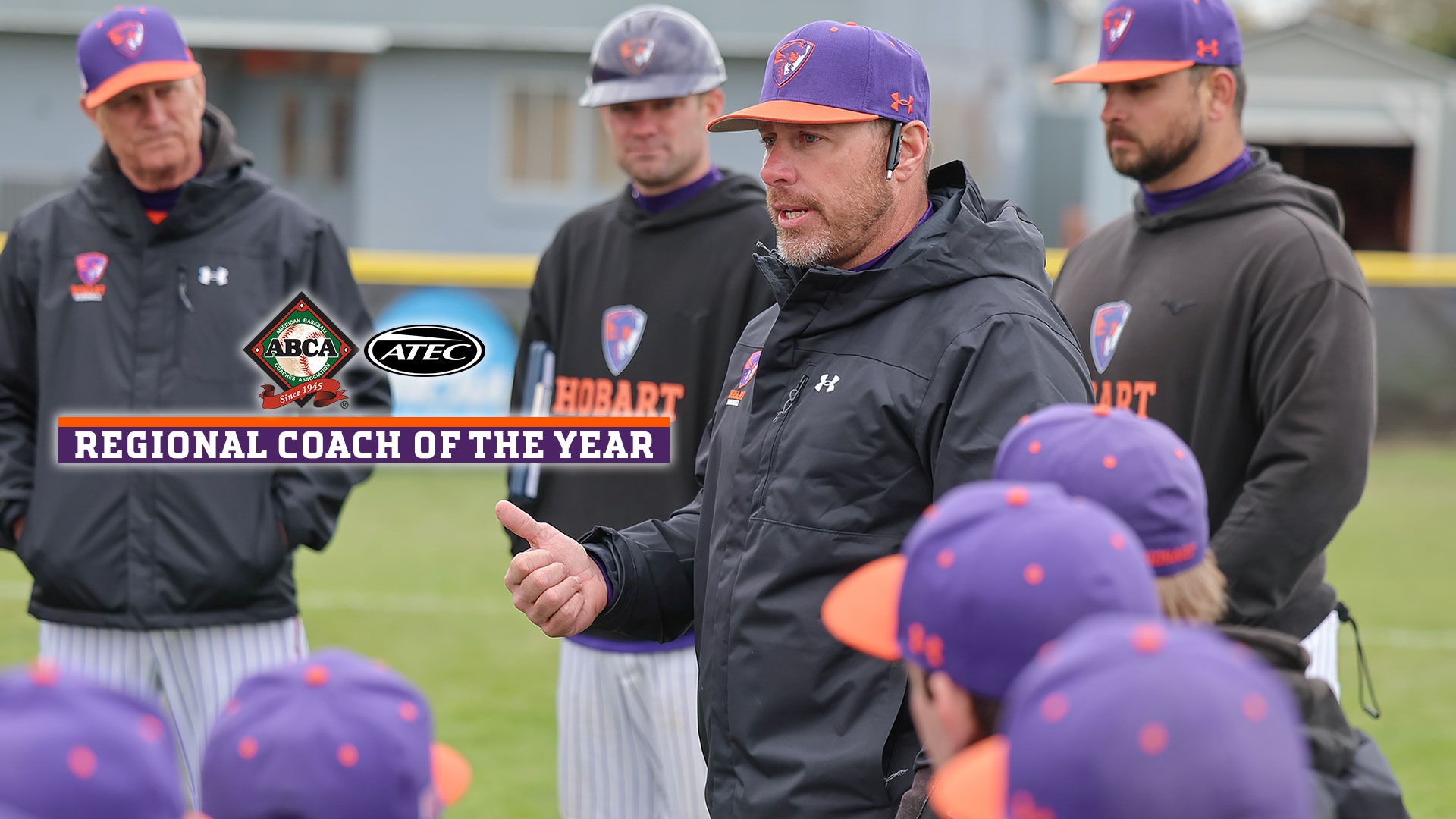 Brad Cook, with his assistant coaches standing behind him, talks to the team after a win over Bard.