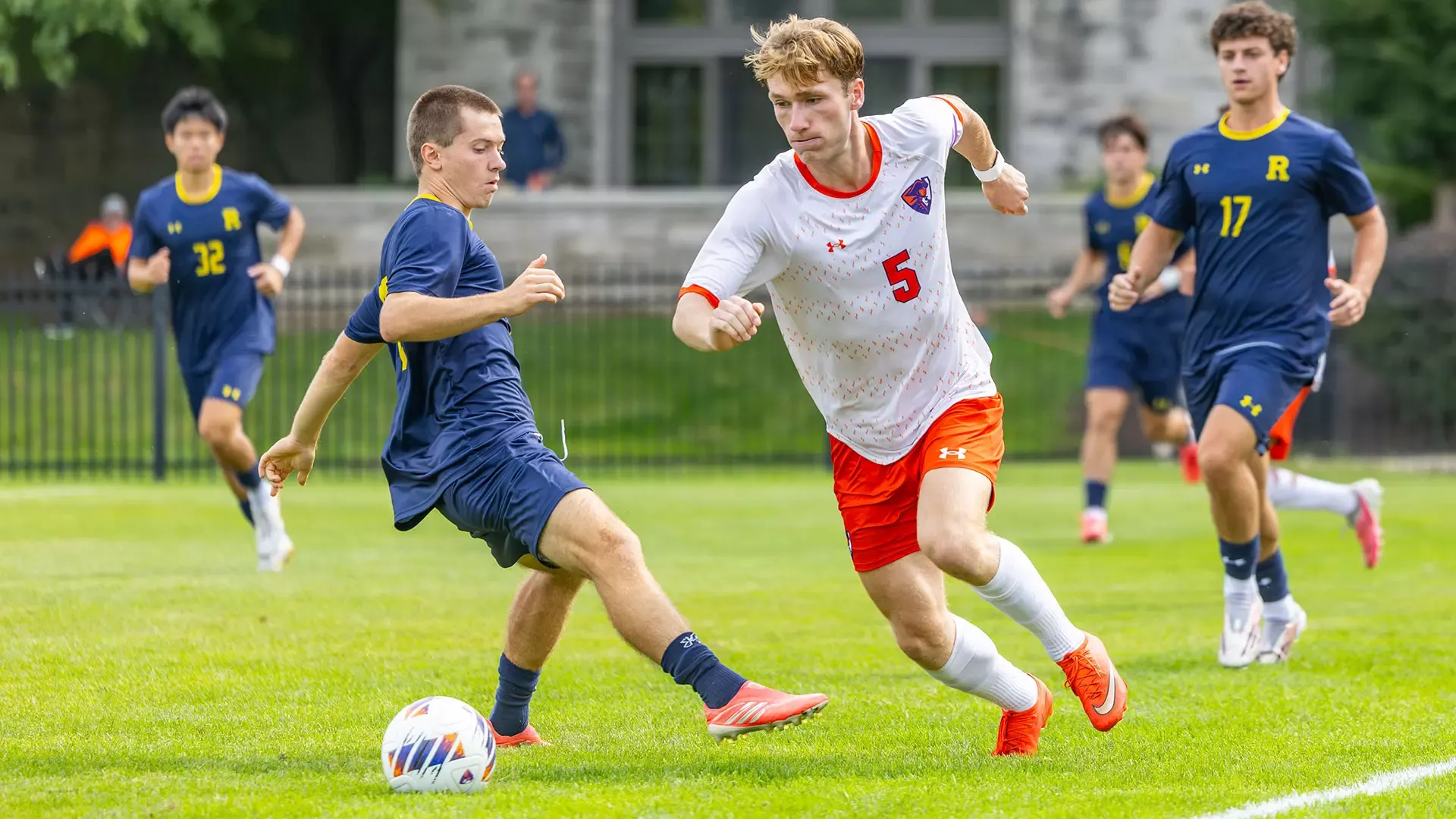 Quinn Phillips defends the ball against players from the other team.
