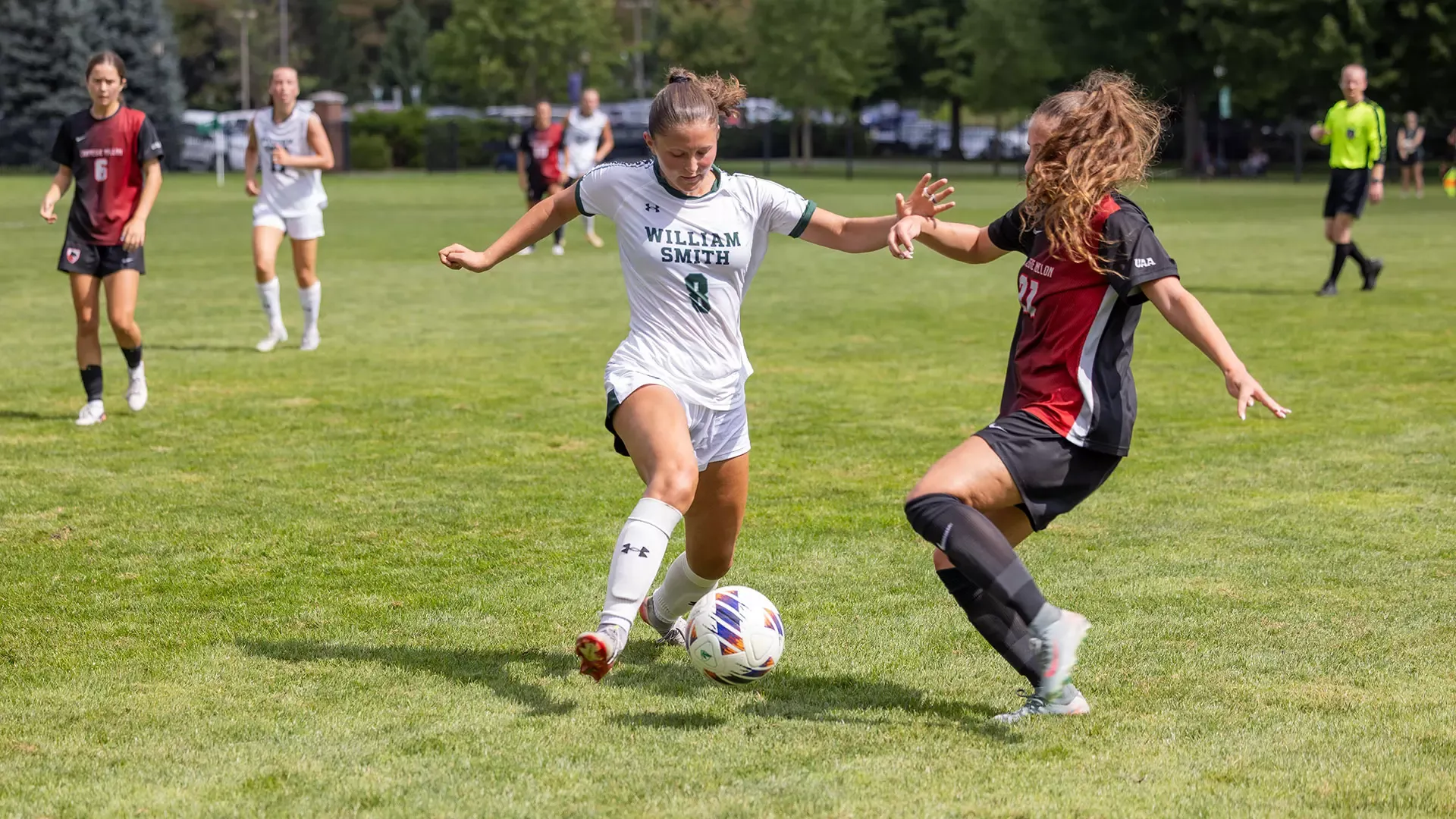 Brynn Schneider fights off a defender 