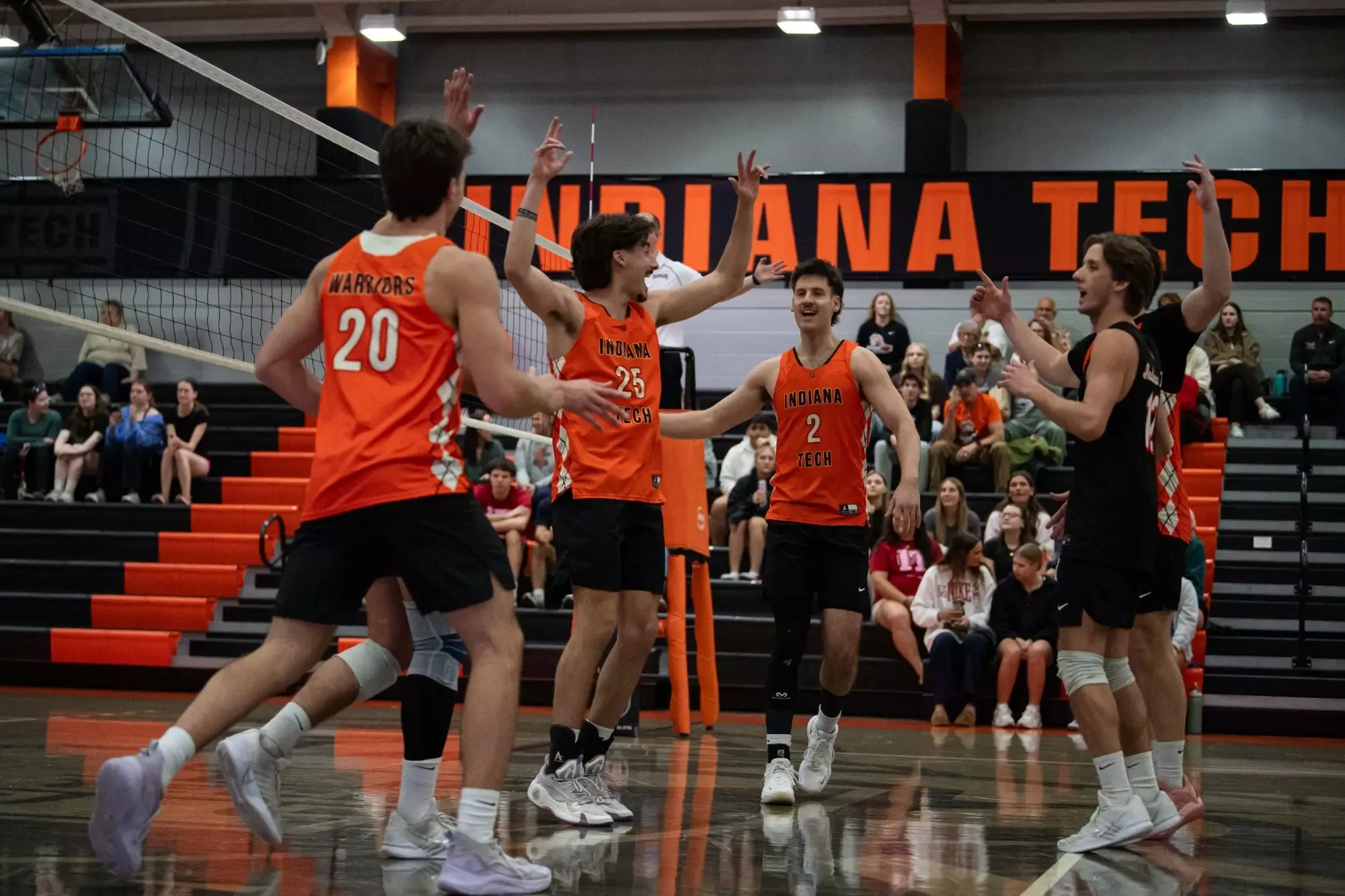 group of men's volleyball seniors celebrating 