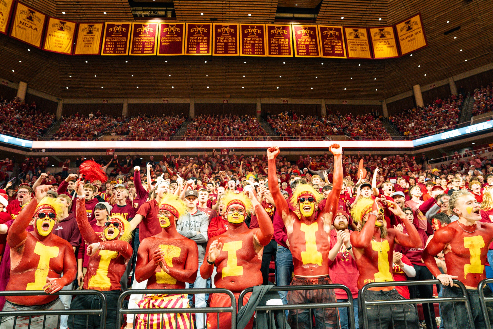 A painted row of students leading Cyclone Alley at Hilton Coliseum