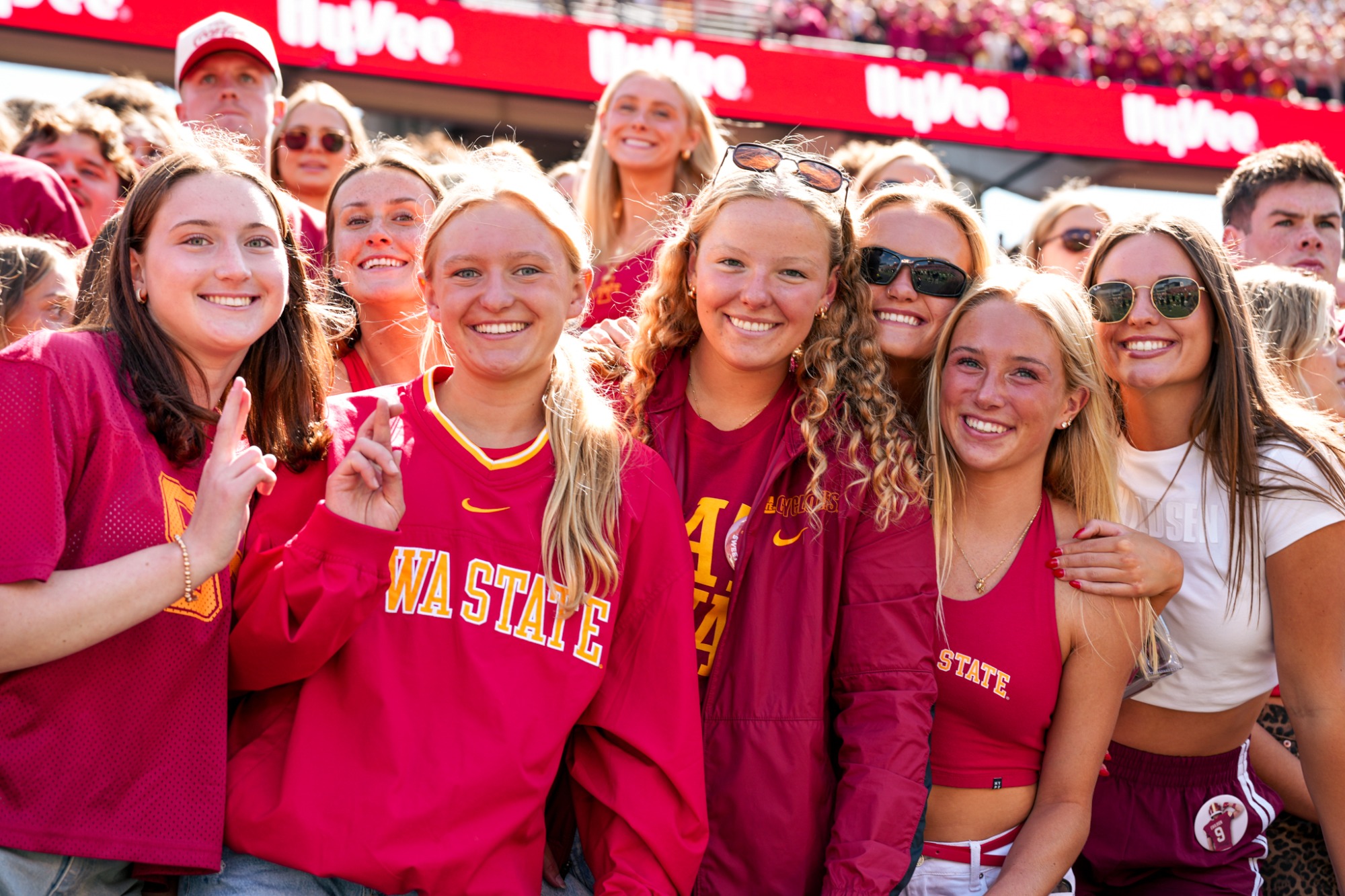 Students smiling in the football student section