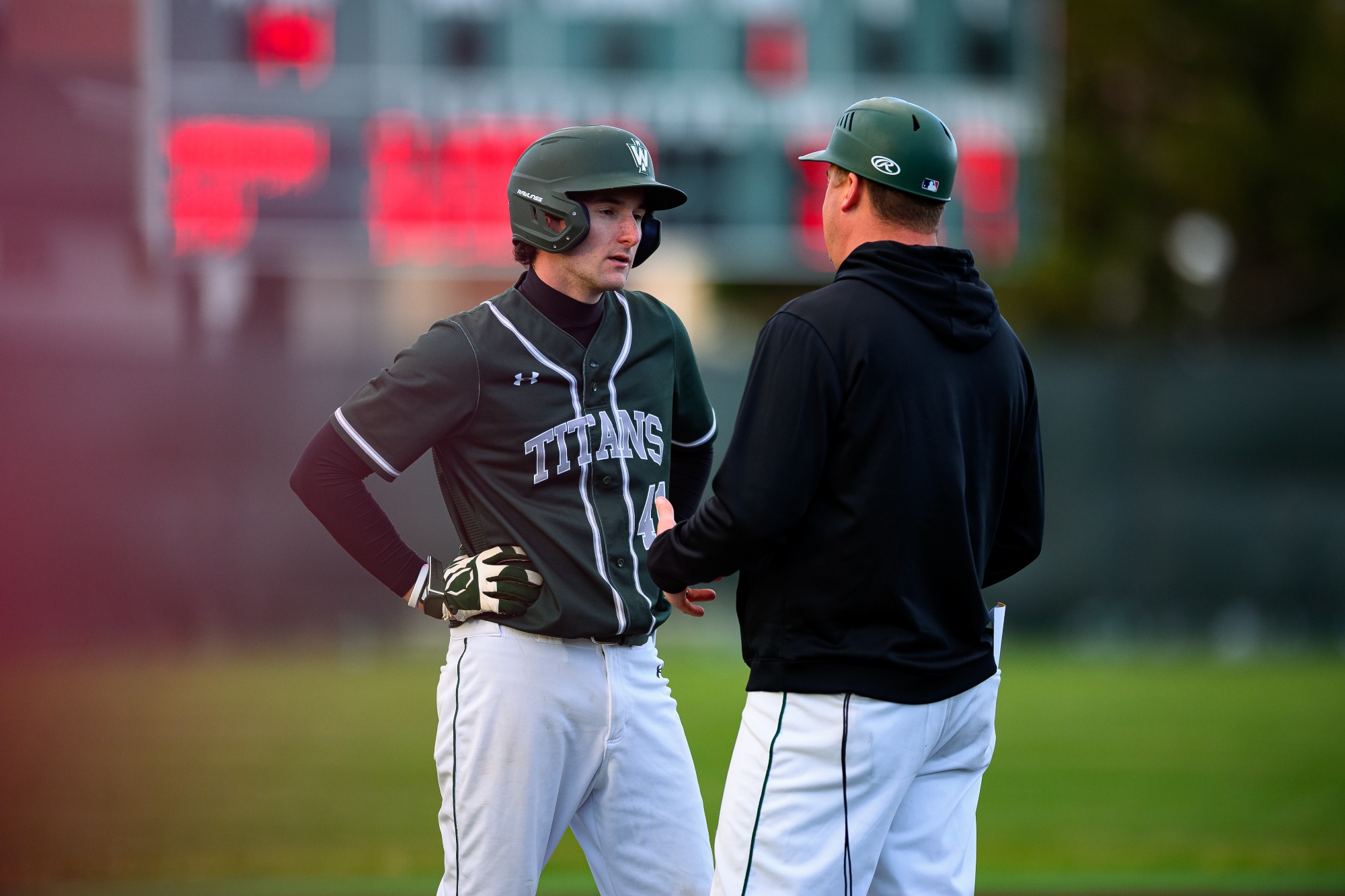 Jack Flagg talking to Head Coach Michael Kellar at third base