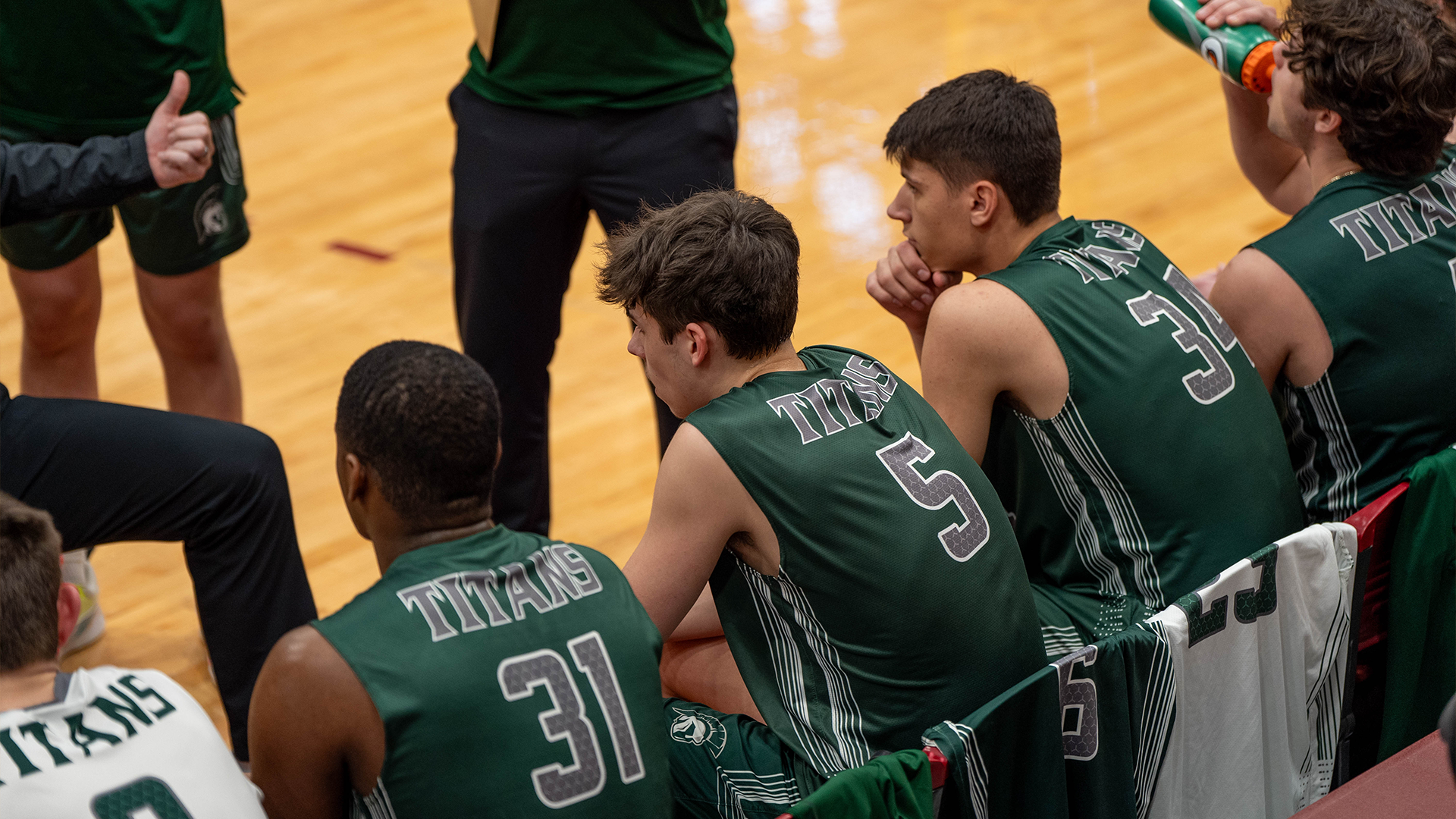 Men's volleyball on bench during timeout
