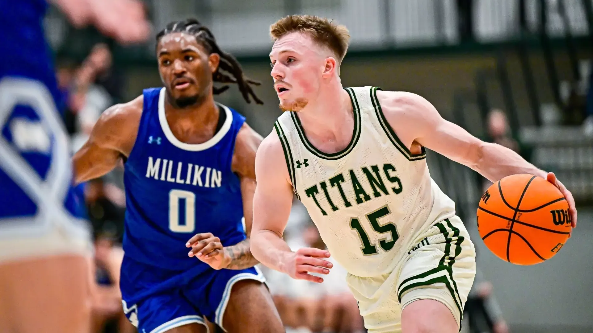 Jackson Niego driving against Millikin Wednesday, Jan. 21